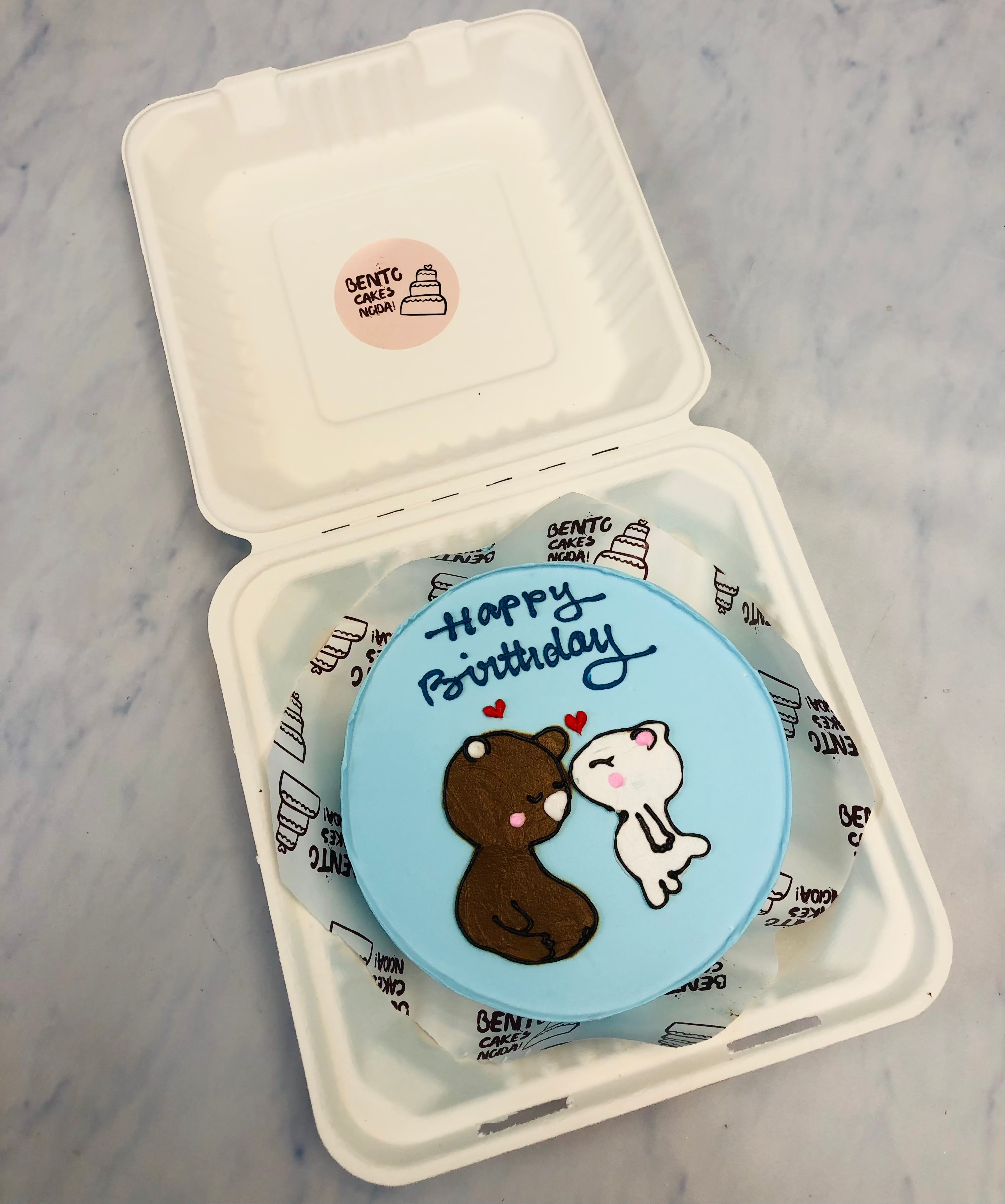 A light blue bento cake with cute bubu dudu drawing celebrating birthday.