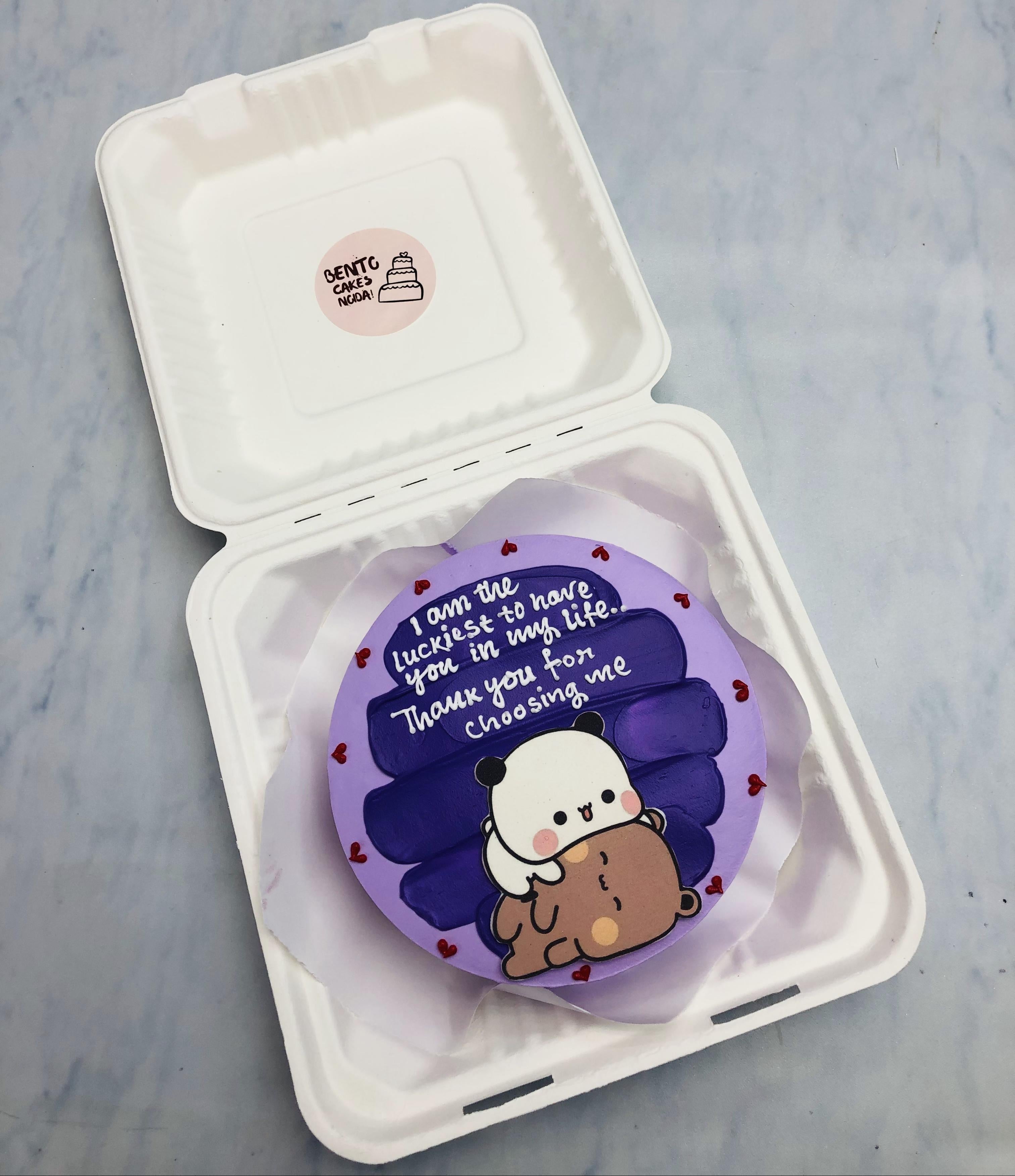 A purple bento cake having blue shades on top and a sleepy bubu dudu print on it with a loving text.