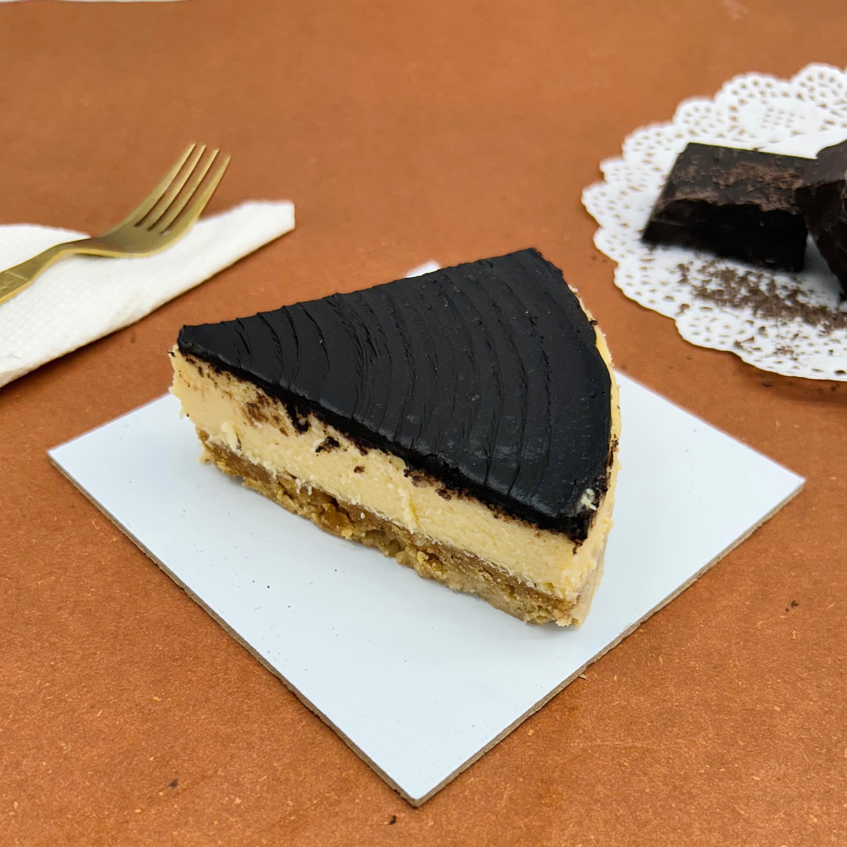 A cheesecake slice made with fresh dark chocolate.
