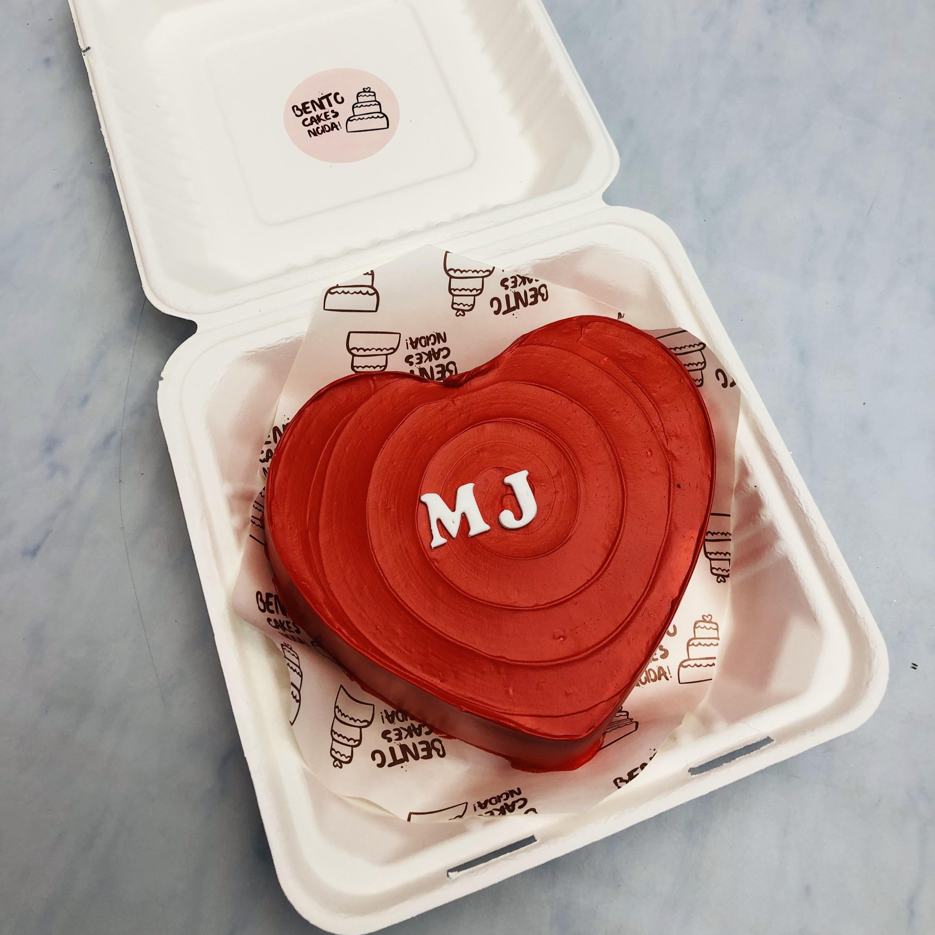 A Dark Red Heart Bento Cake with fondant alphabet "MJ" on it.
