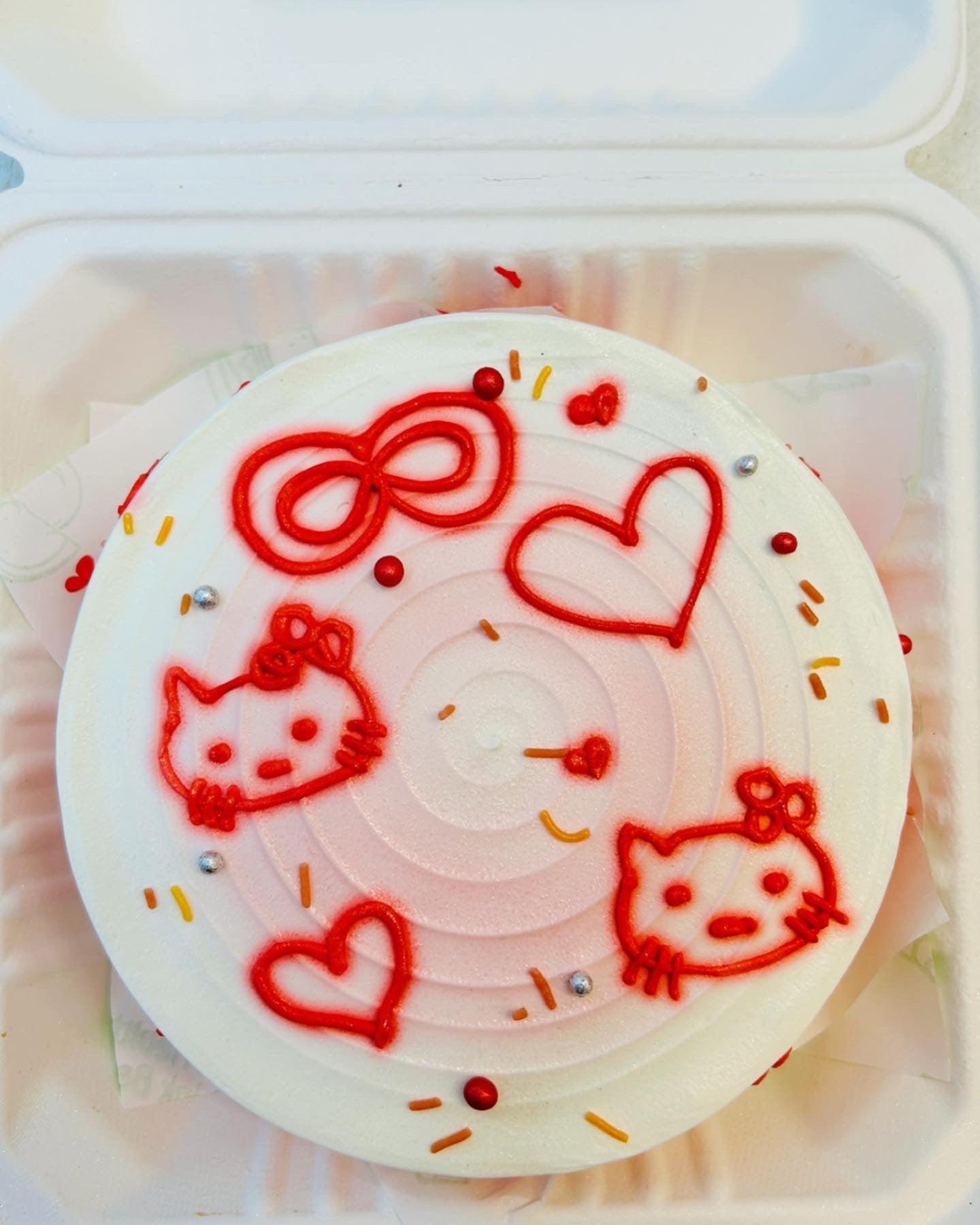 A delightful cake adorned with colorful Hello Kitty designs, perfect for a fun celebration or birthday party.