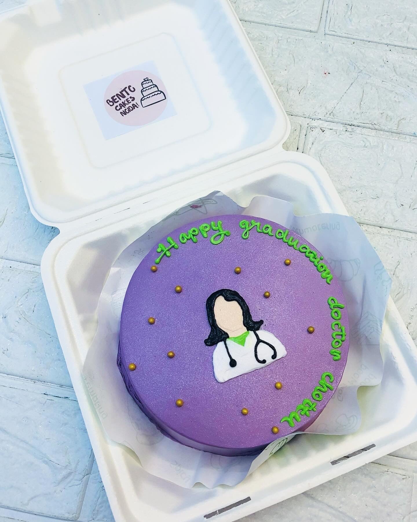 A shiny purple bento having a fe,male doctor design on it for compleating her graduation.