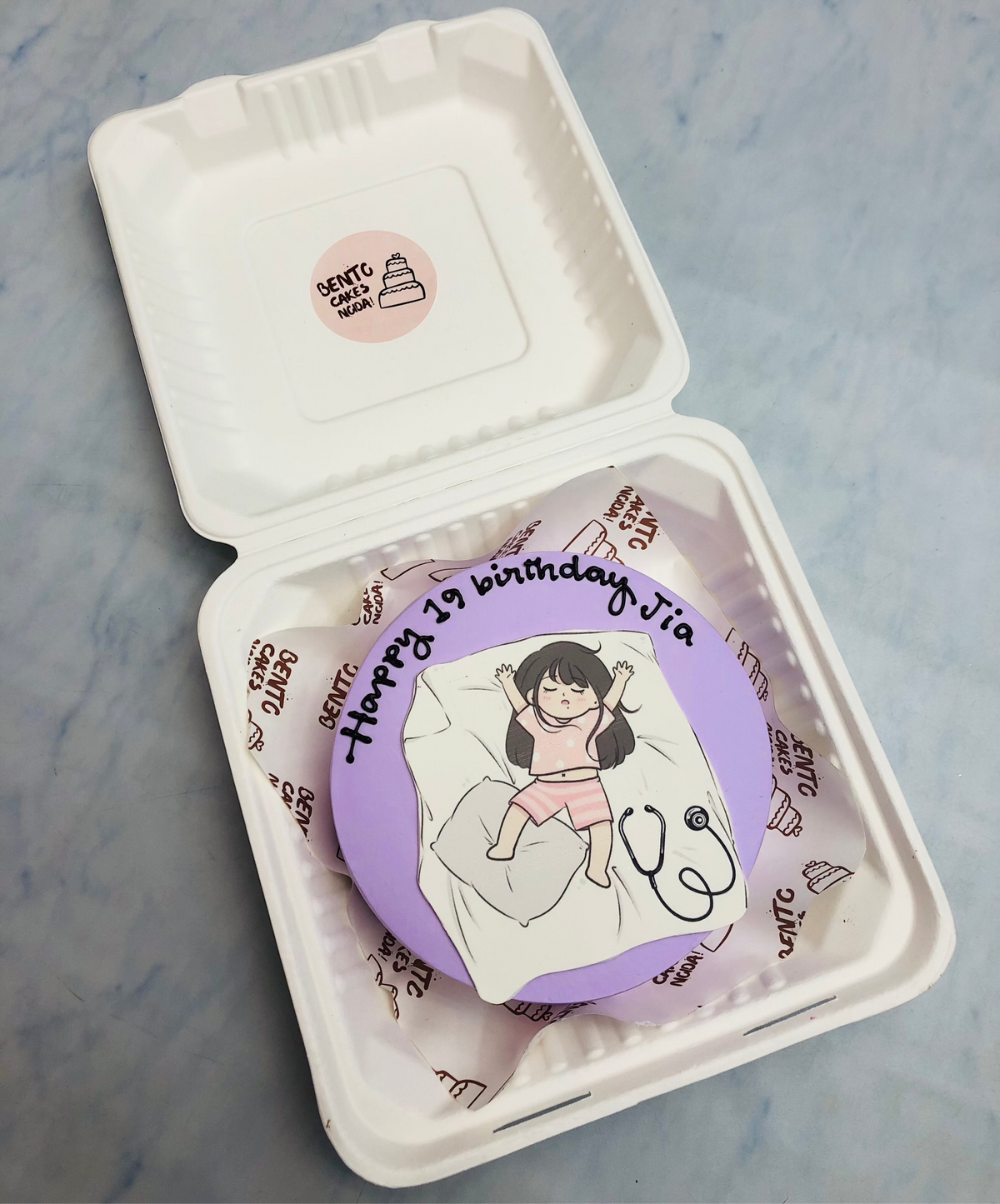 A light purple bento cake is designed for doctor girls 19th birthday.