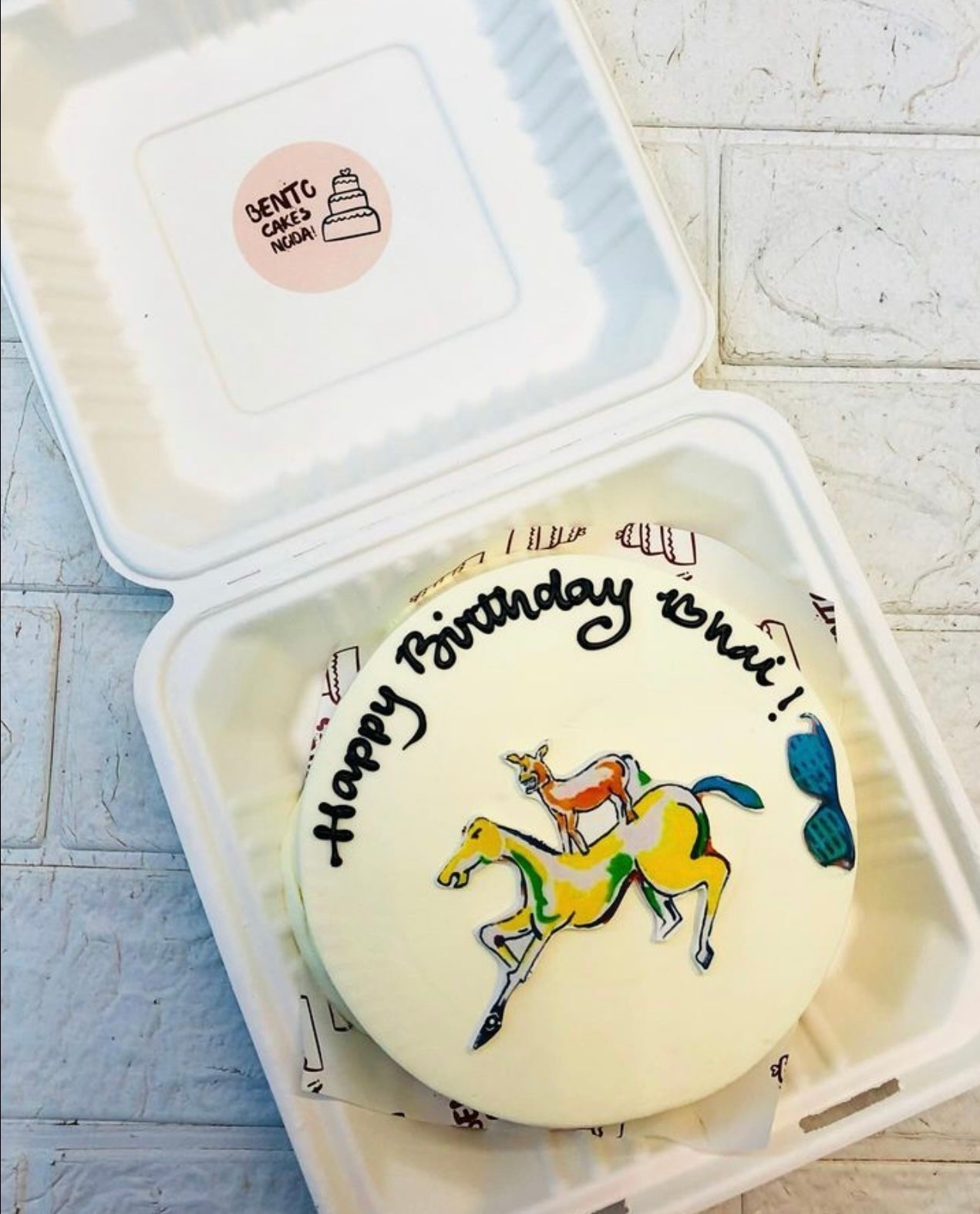 A white bento cake showing a horse and a donkey friendship theme.