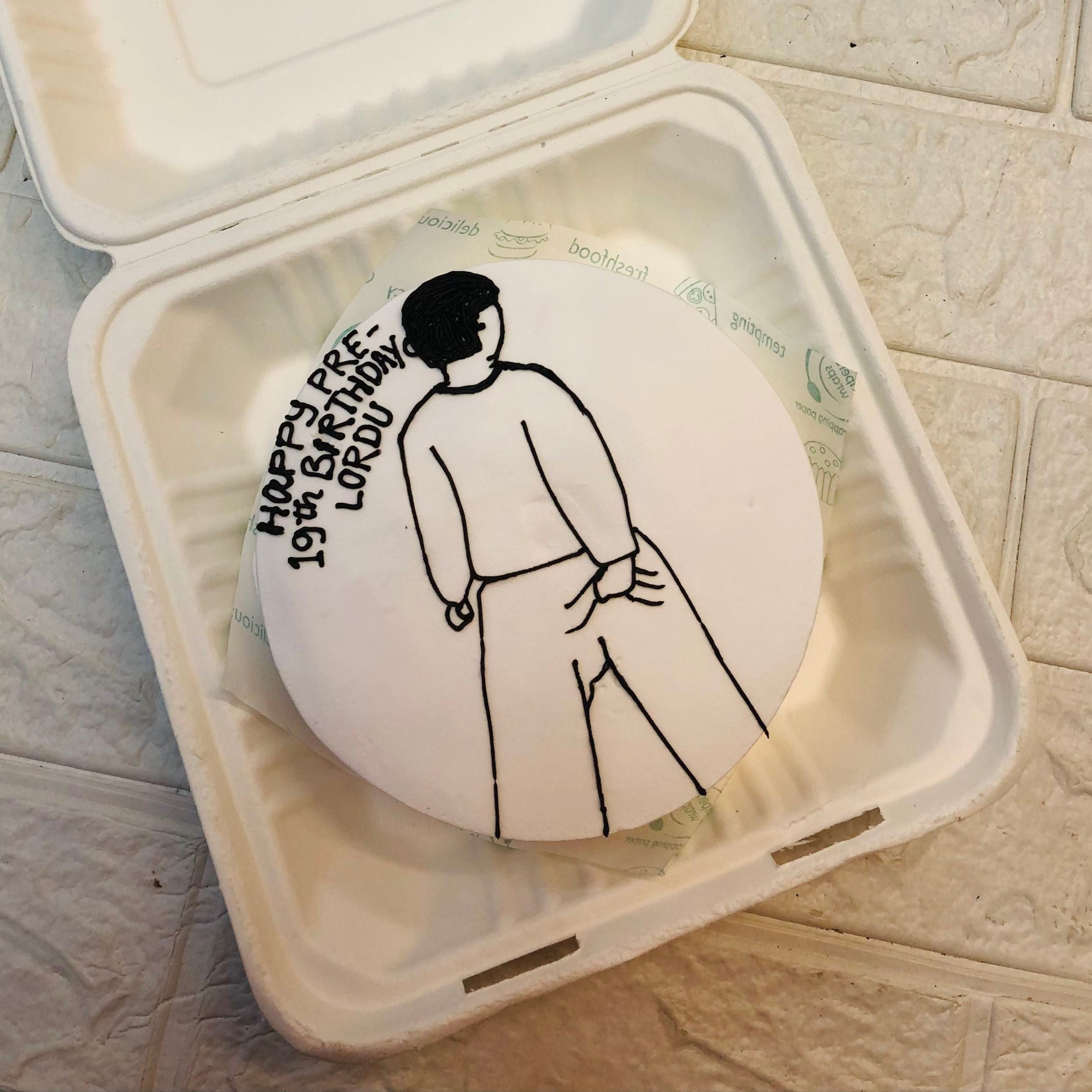 A white box featuring a drawing of a man, showcasing a simple yet engaging artistic representation.