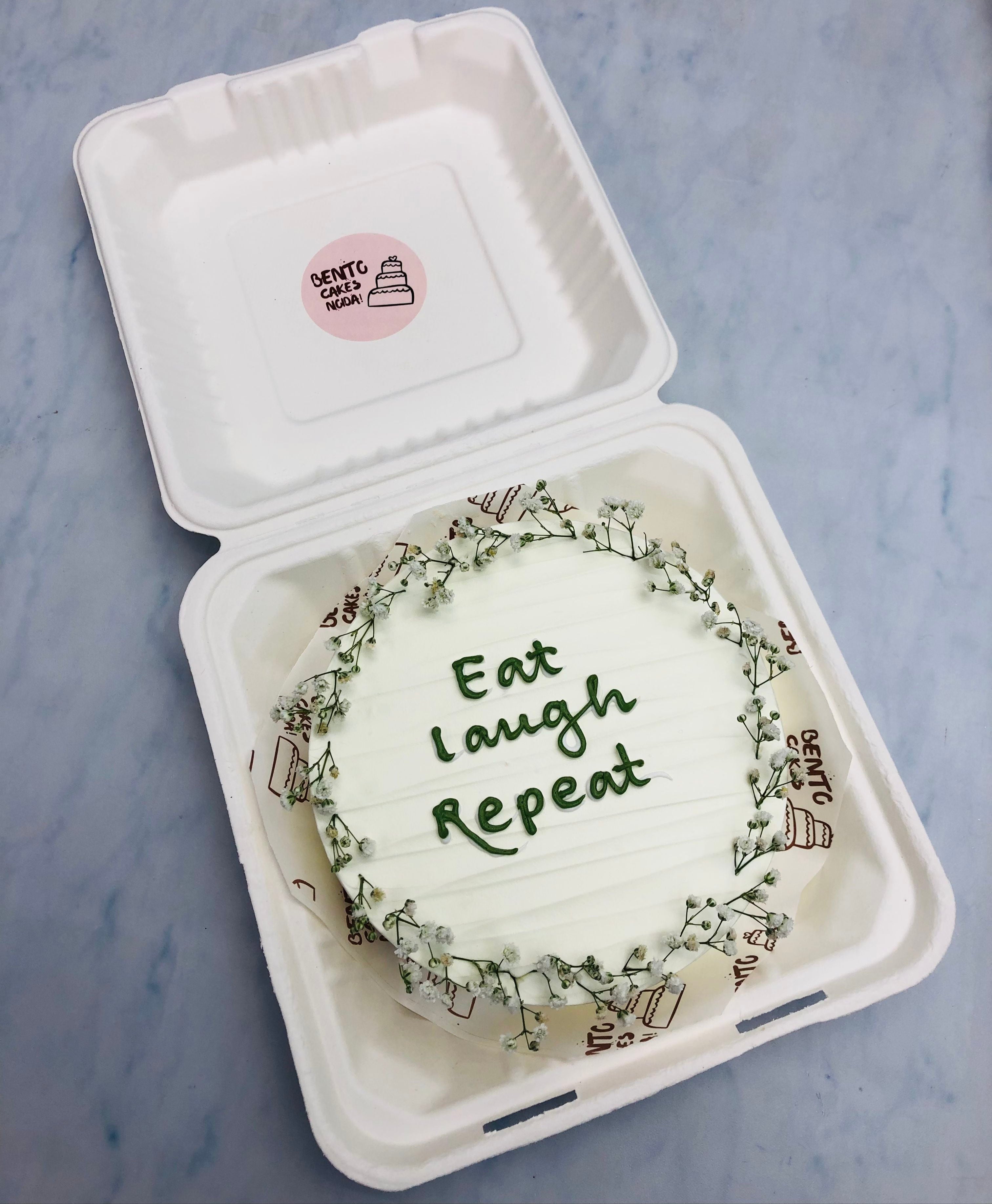 A white bento cake decorated with vintage white florals on it's boundary.