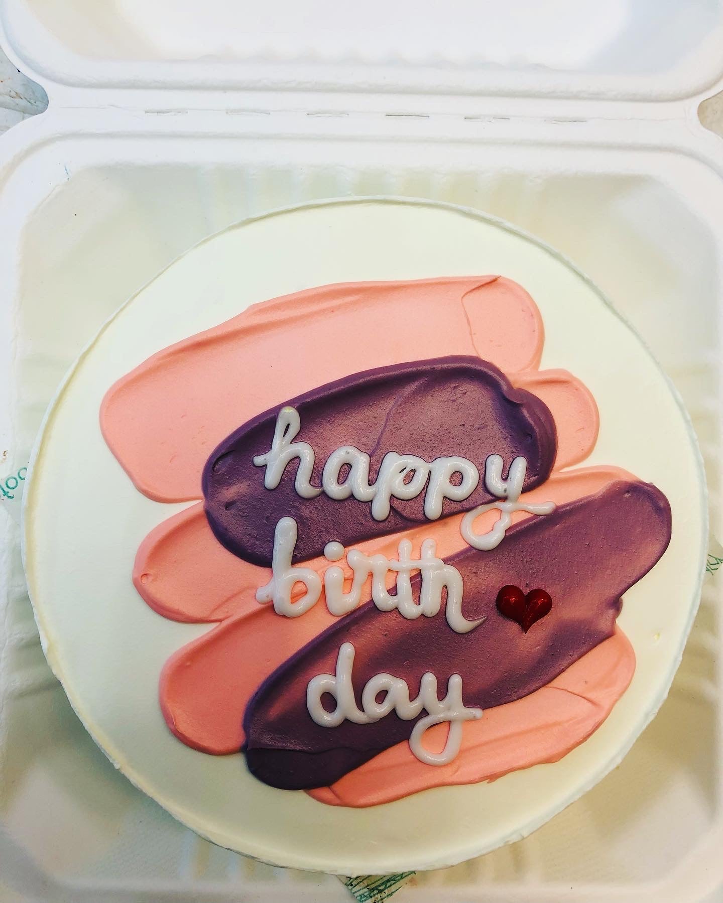 A birthday cake adorned with colorful frosting and the words "Happy Birthday" elegantly written on top.