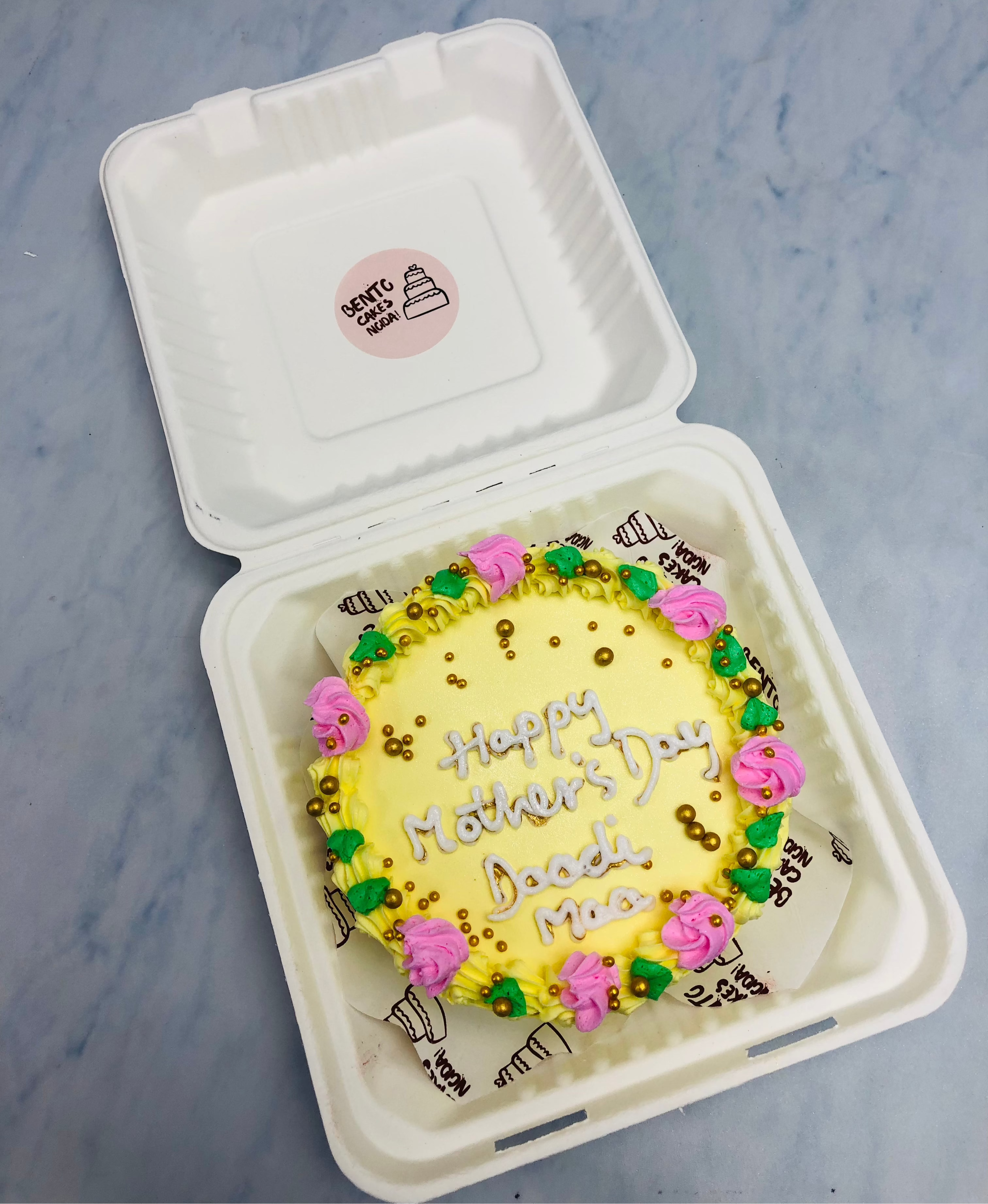 An elegant florals design on light yellow bento cake decorated with golden sprinkles for mothers day.
