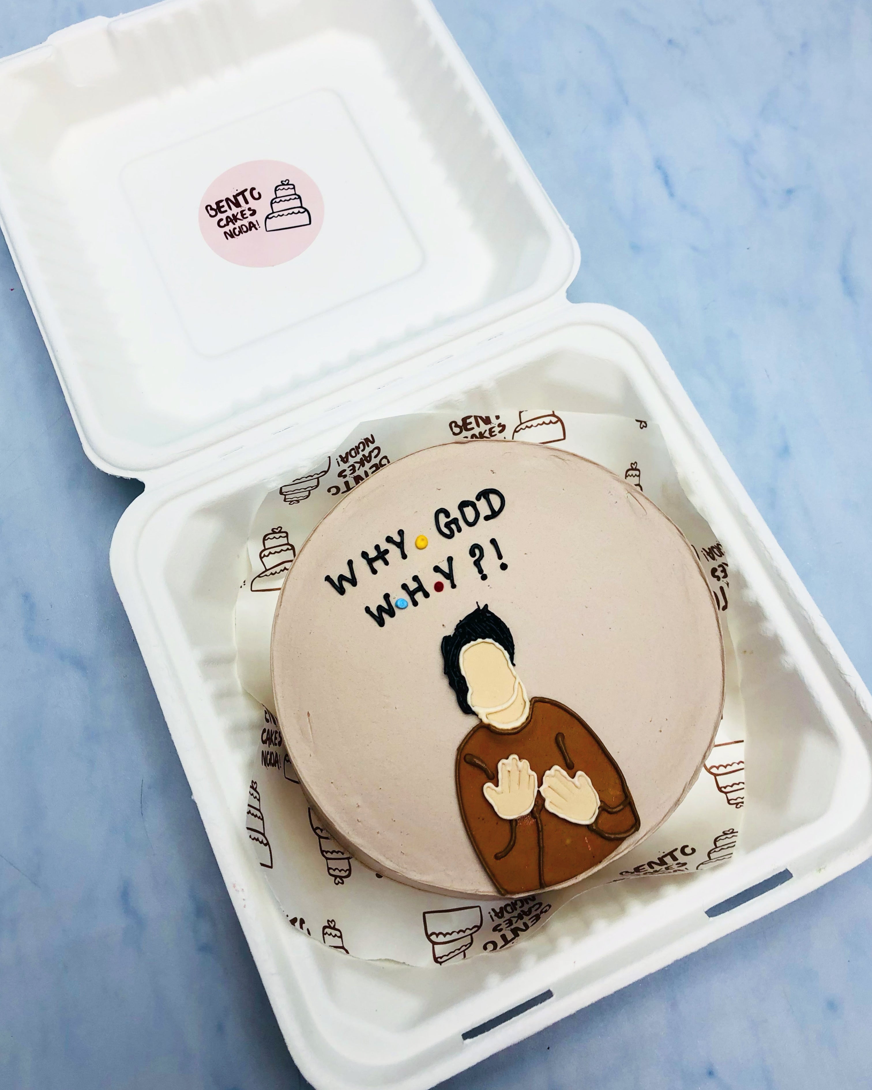 A light brown bento cake having friends series character drawn with cream and a text written with black color.