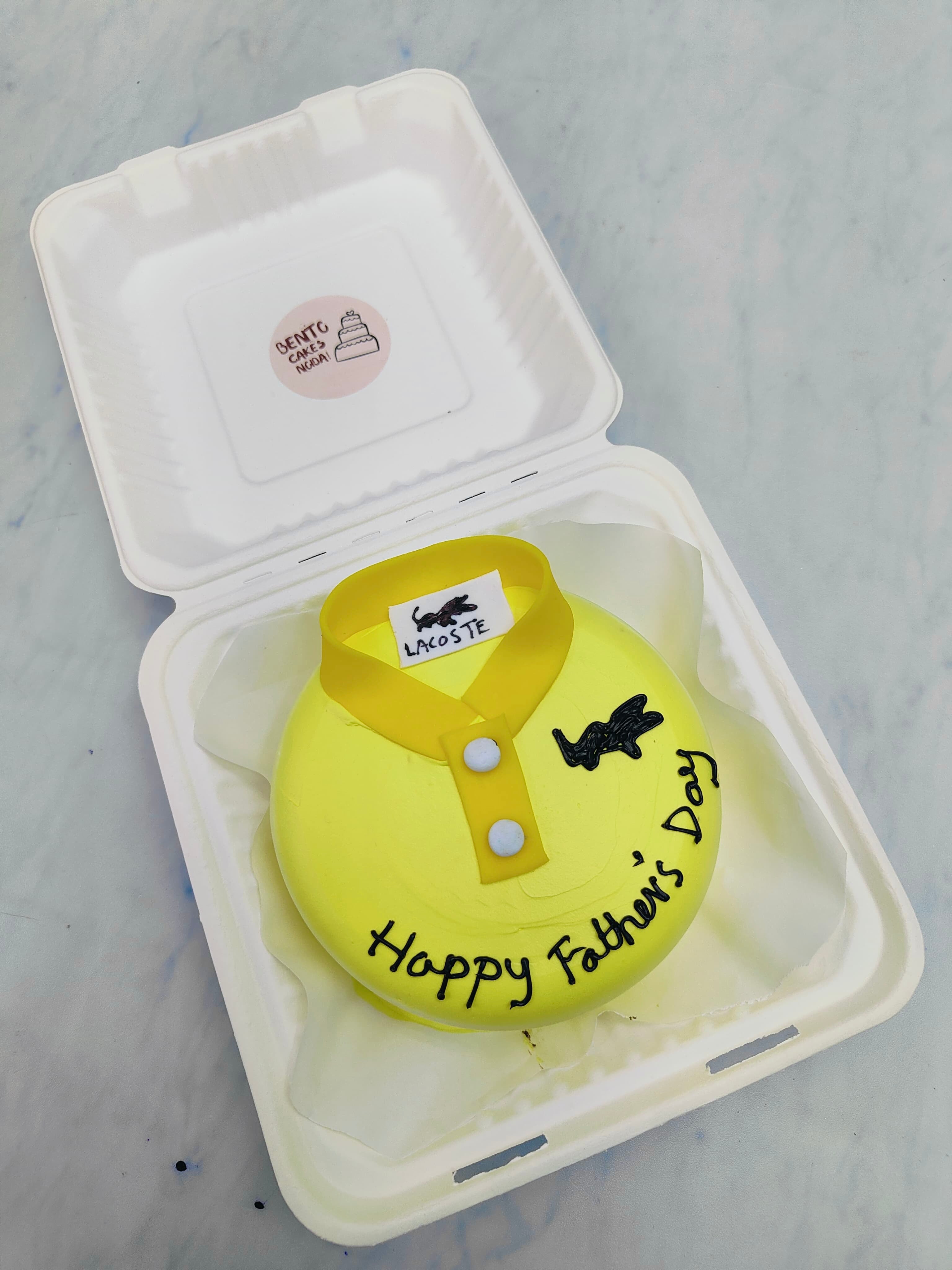 A yellow bento cake is designed for fathers day celebration with a shirt's collor design.