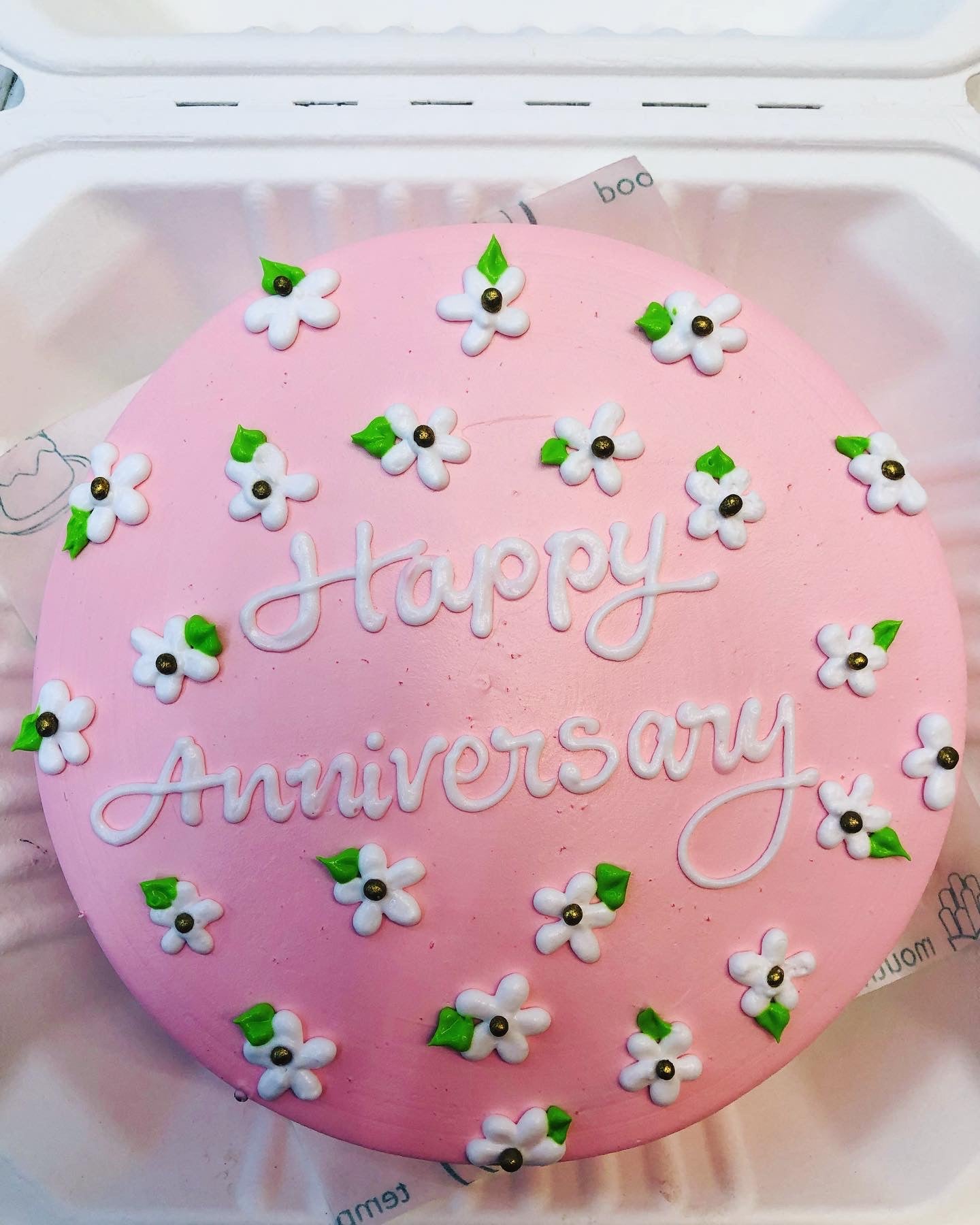 Cake is for Anniversary Celebration with floral theme on the top.