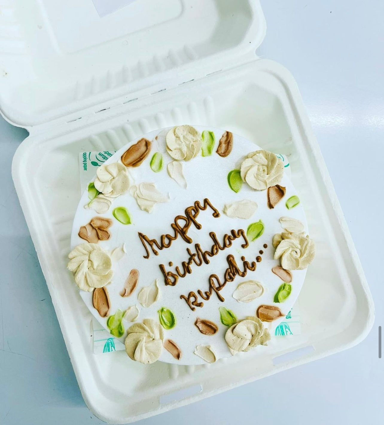 A beautifully decorated birthday cake inside a bento box, ideal for keeping it fresh for the special celebration.