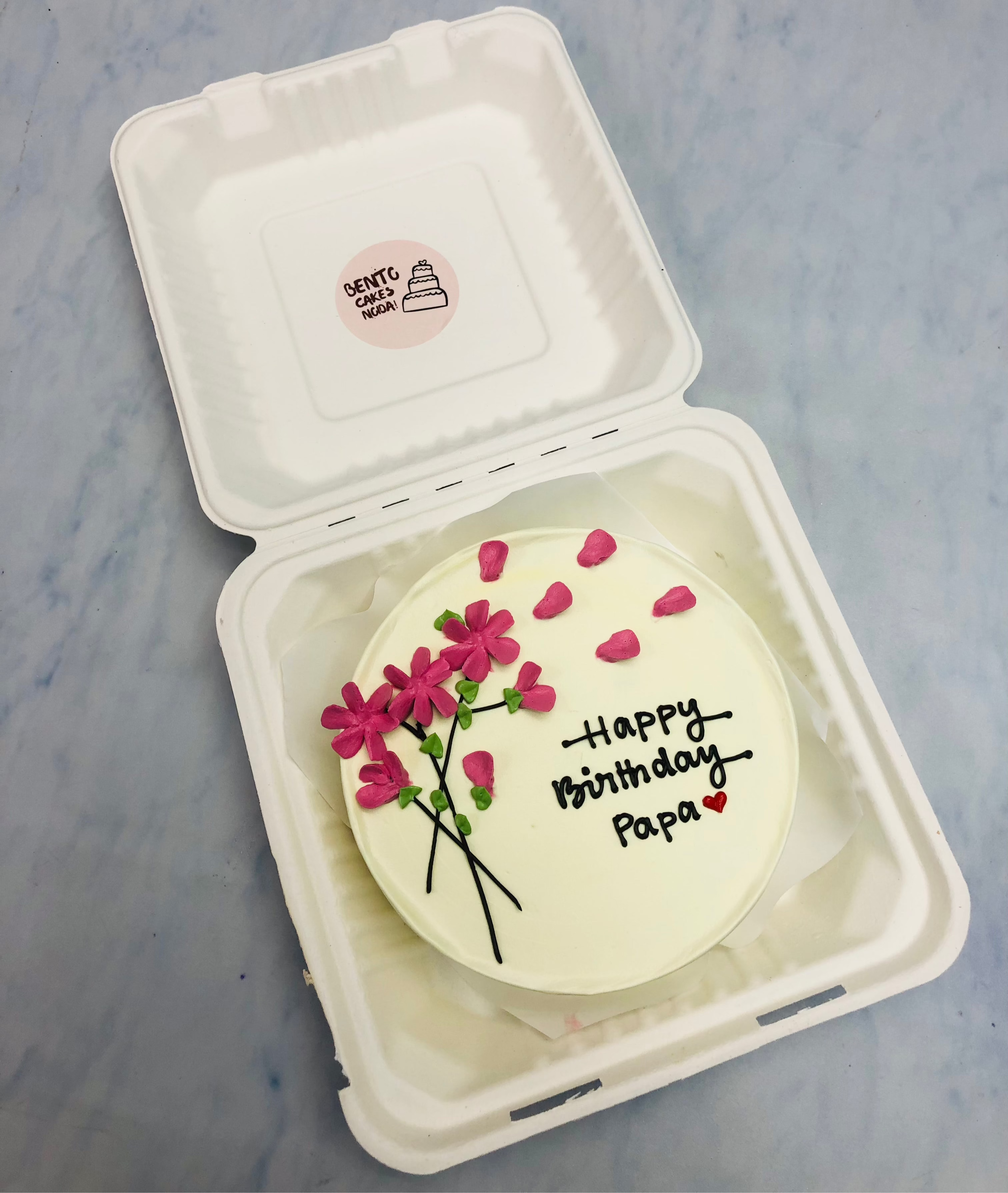 A pretty florals design on a white bento with pink florals and is designed for fathers birthday.