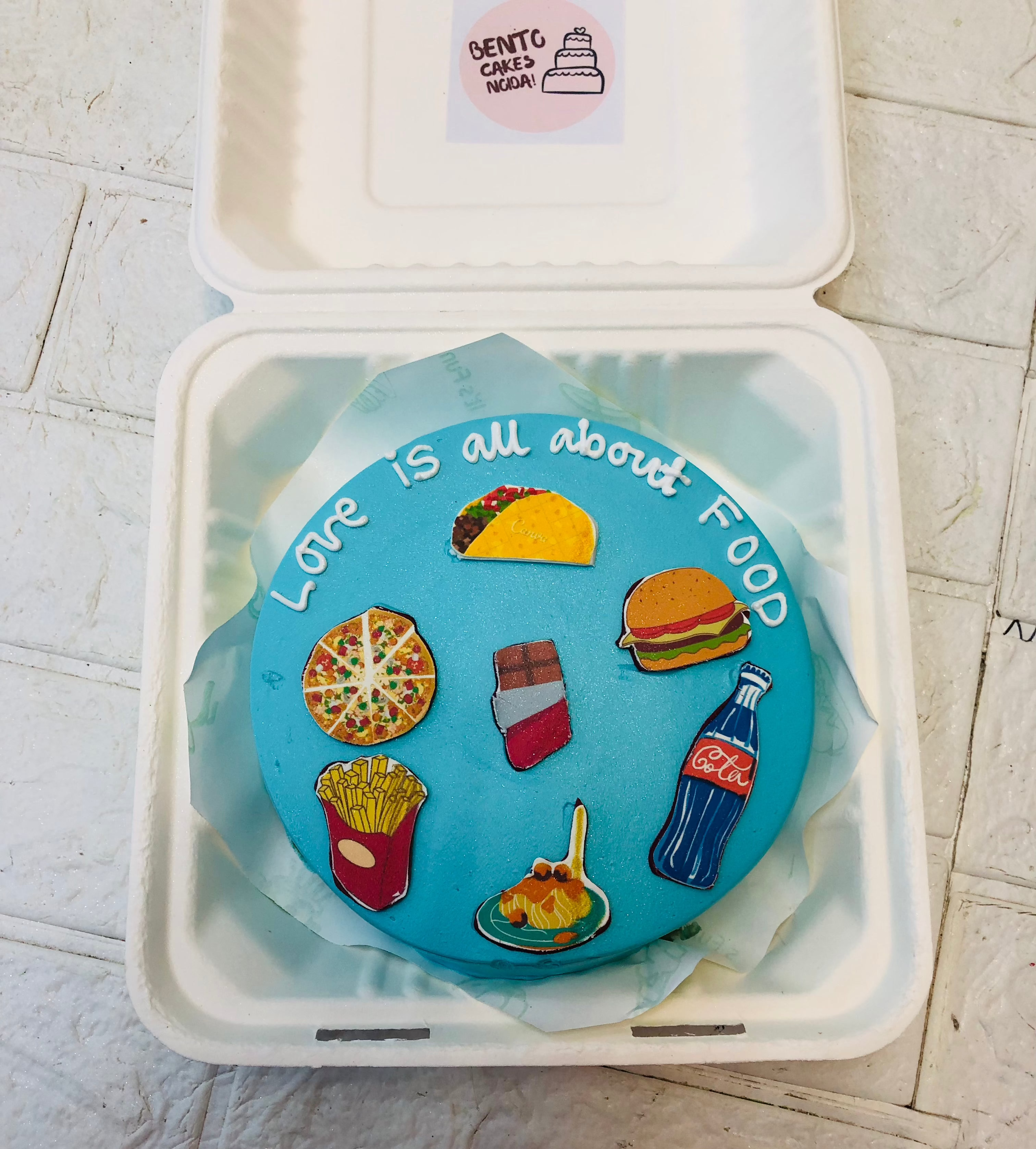 A food lovers favourite items printe on a skyblue bento cake.
