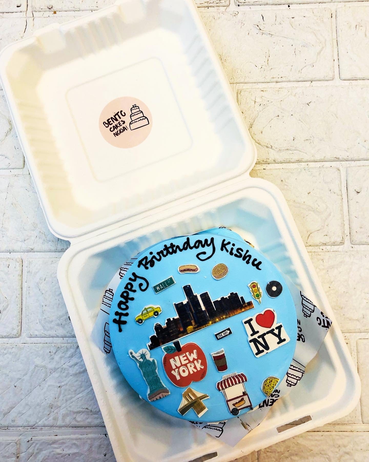 A light blue bento cake is designed for world traveller and foodies birthday.
