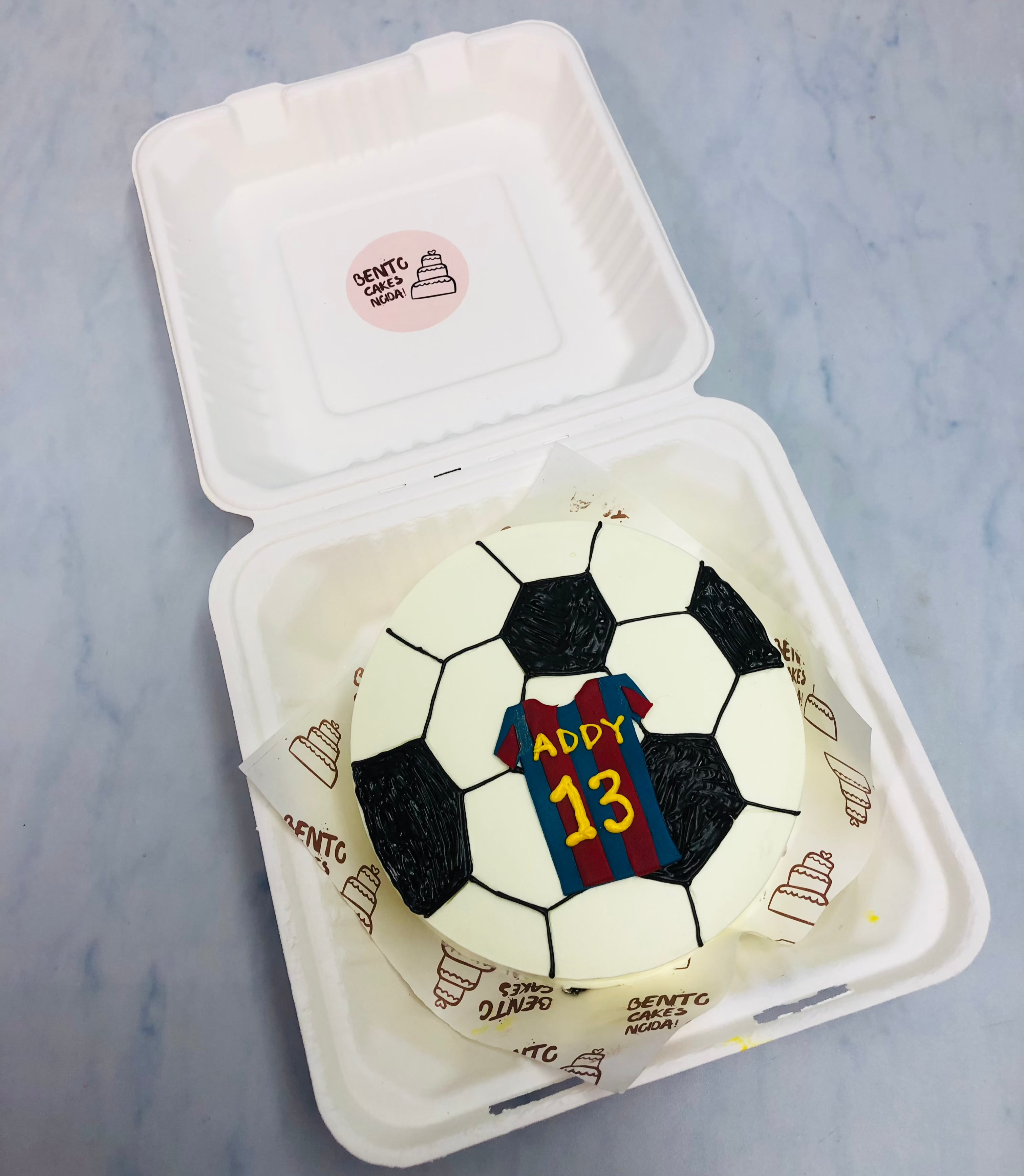 A football design bento cake with player jersey.
