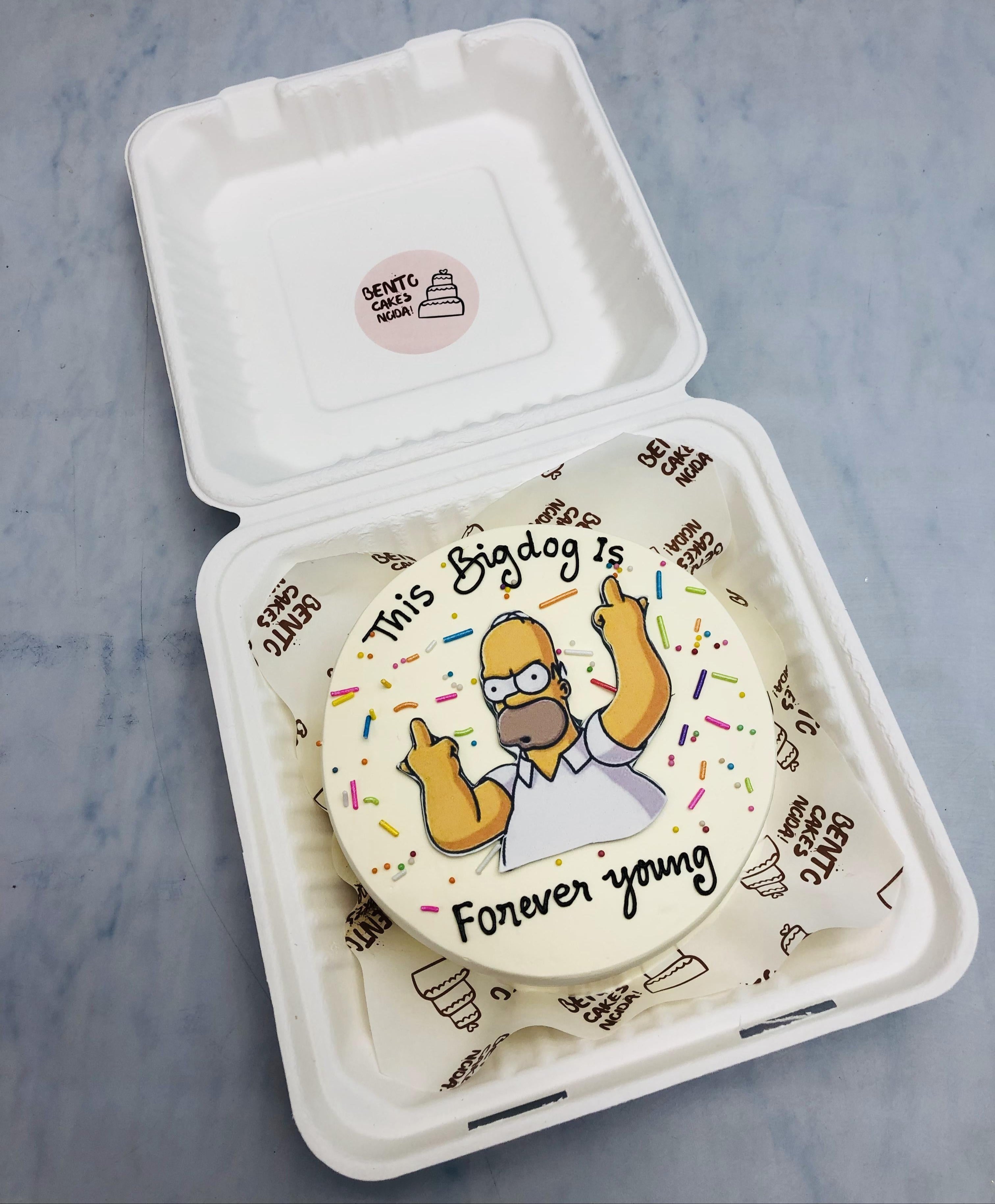 An offwhite bento cake with an old man print enjoying his birthday and a text  "Forever young" written on cake.