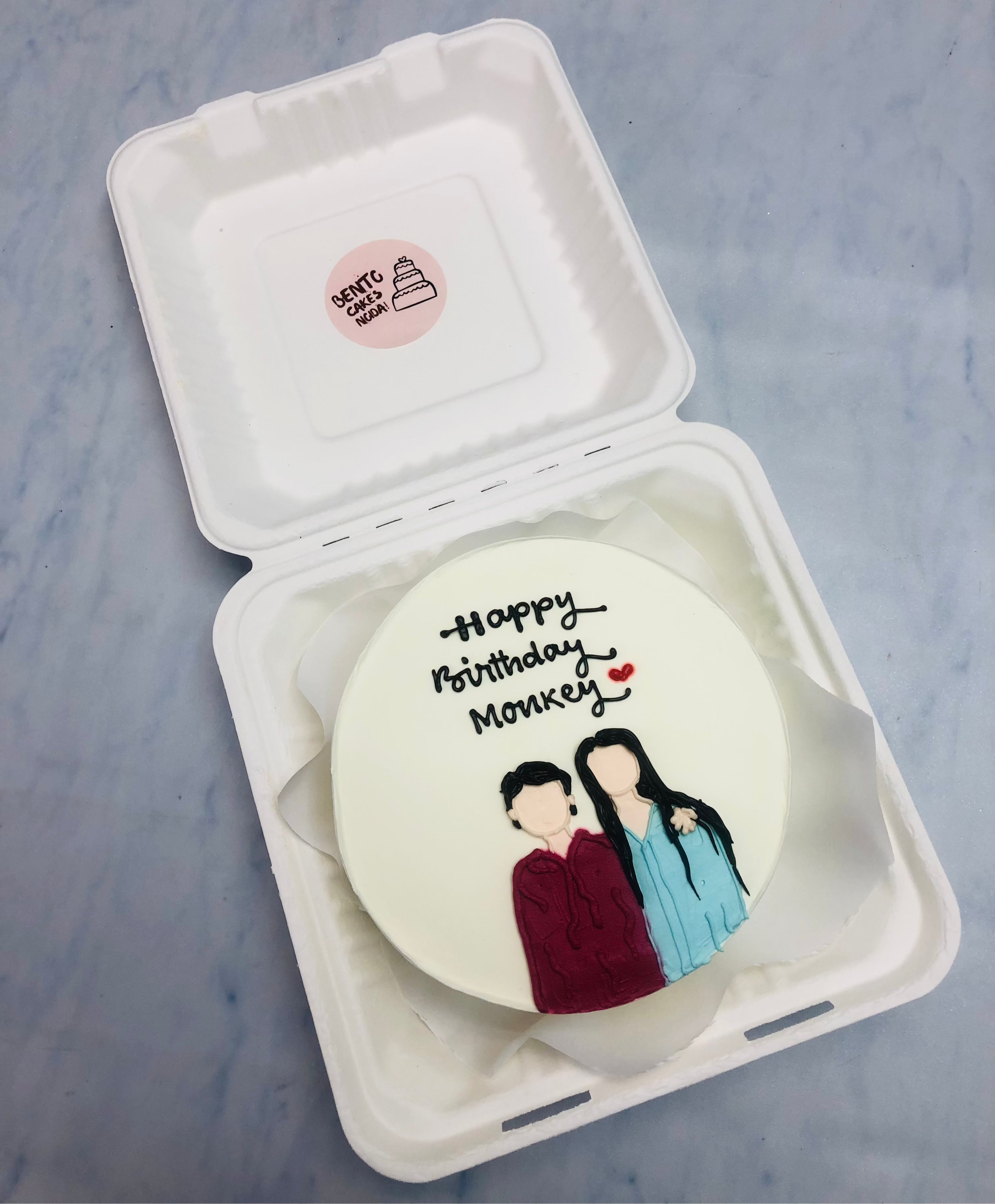 A white bento cake showing a girl and boy friendship, celebrating birthday.