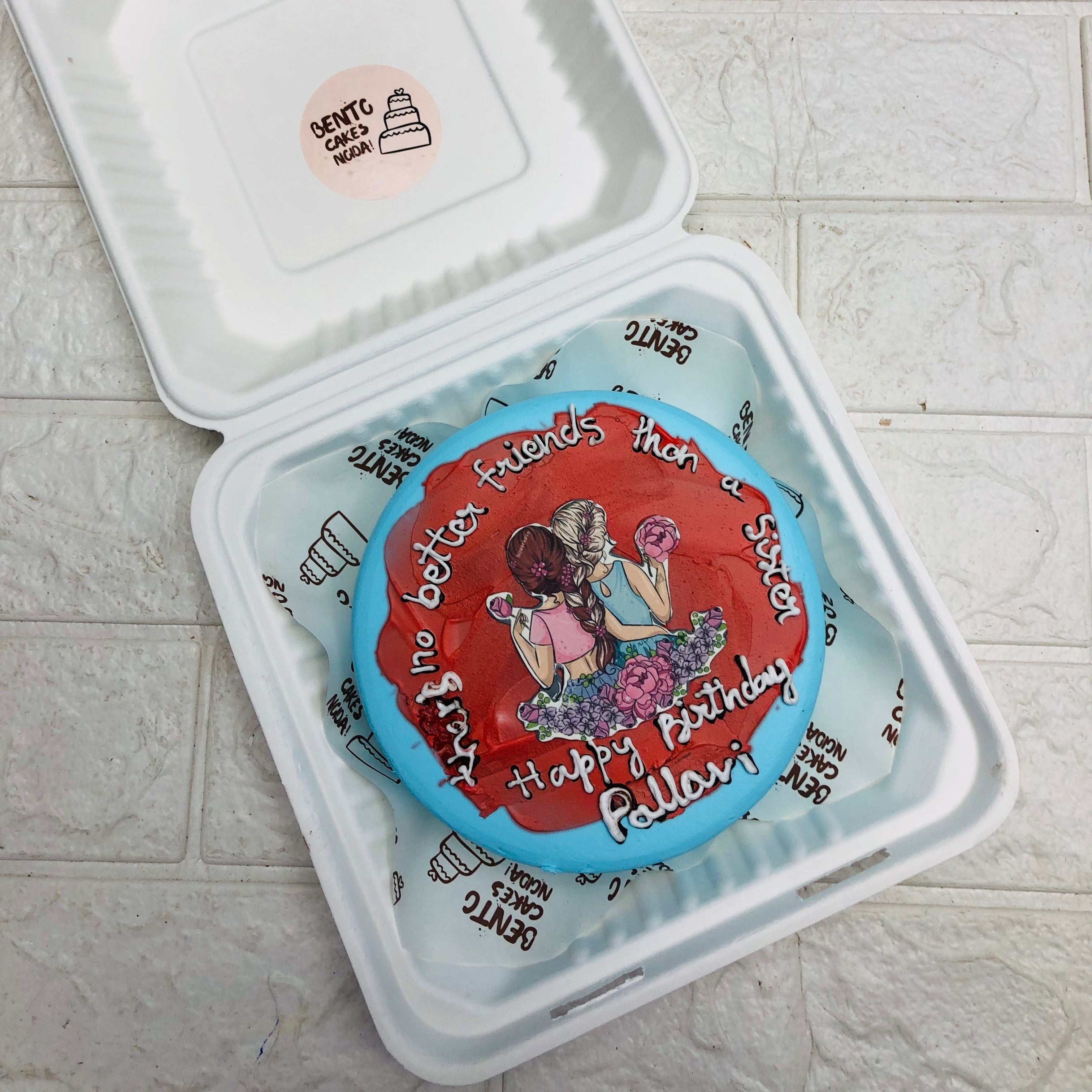 A beautifully decorated cake nestled inside a charming box, with better friends theme ready for a special celebration.