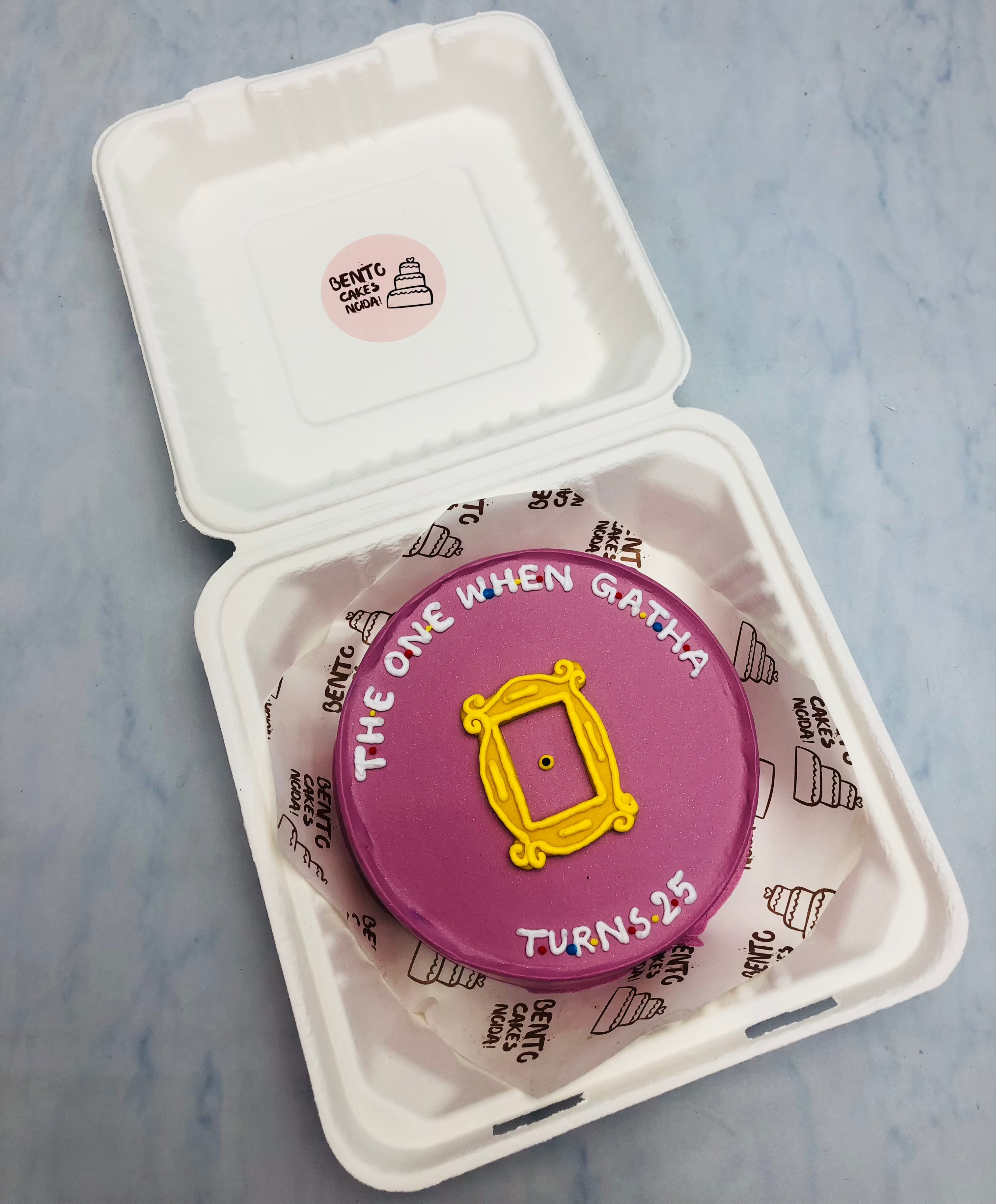 A magenta color bento cake designed with friends series logo.
