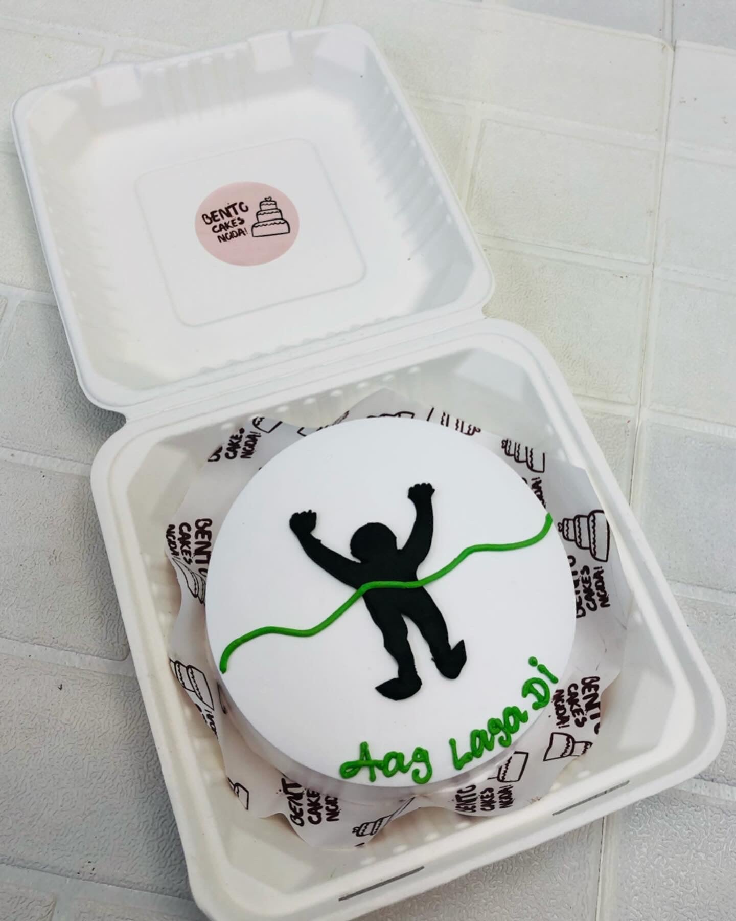A white bento cake with a friend winning race theme with a motivational quote "Aag Laga Di".