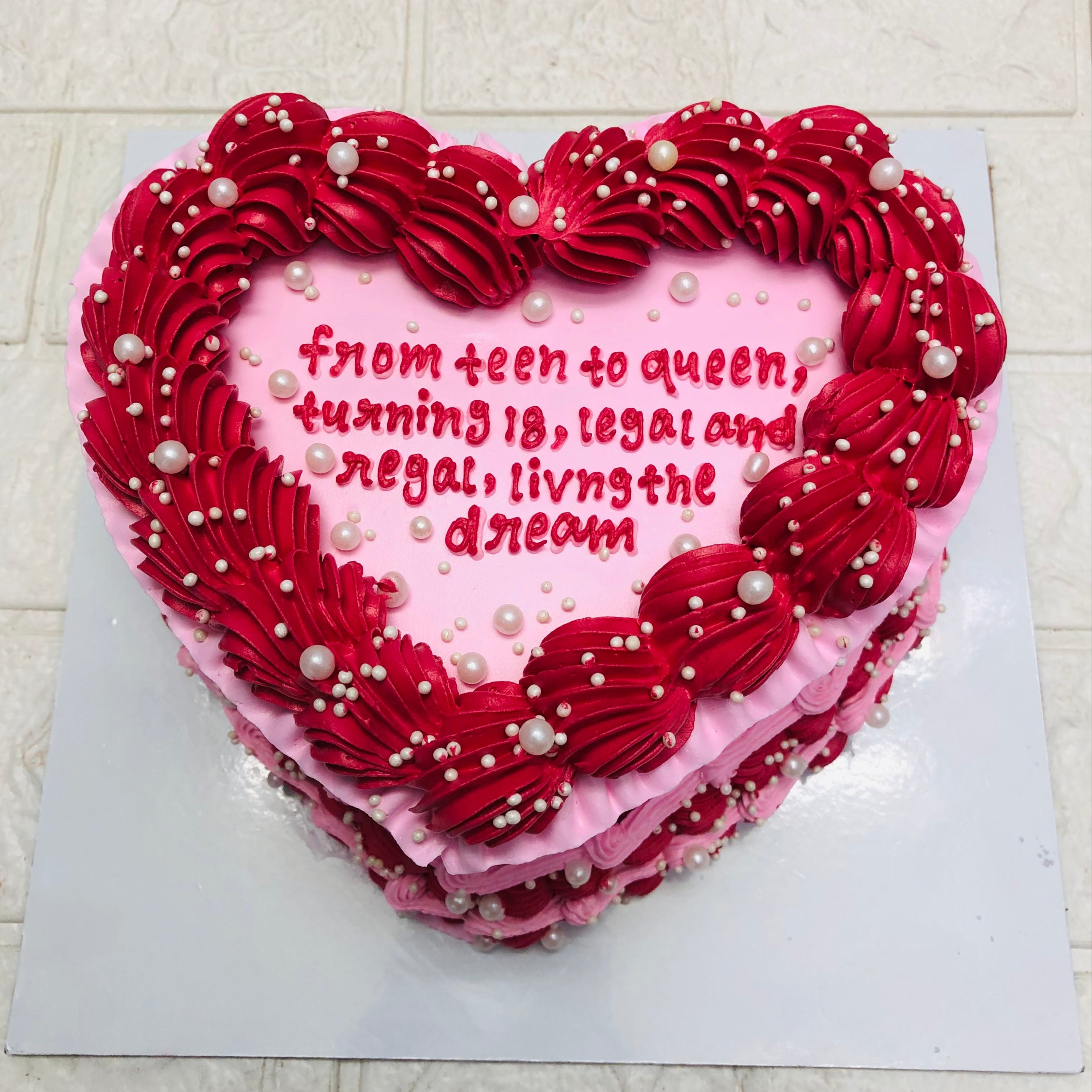 A heart-shaped cake adorned with red icing and a heartfelt message, perfect for celebrations of love and affection.