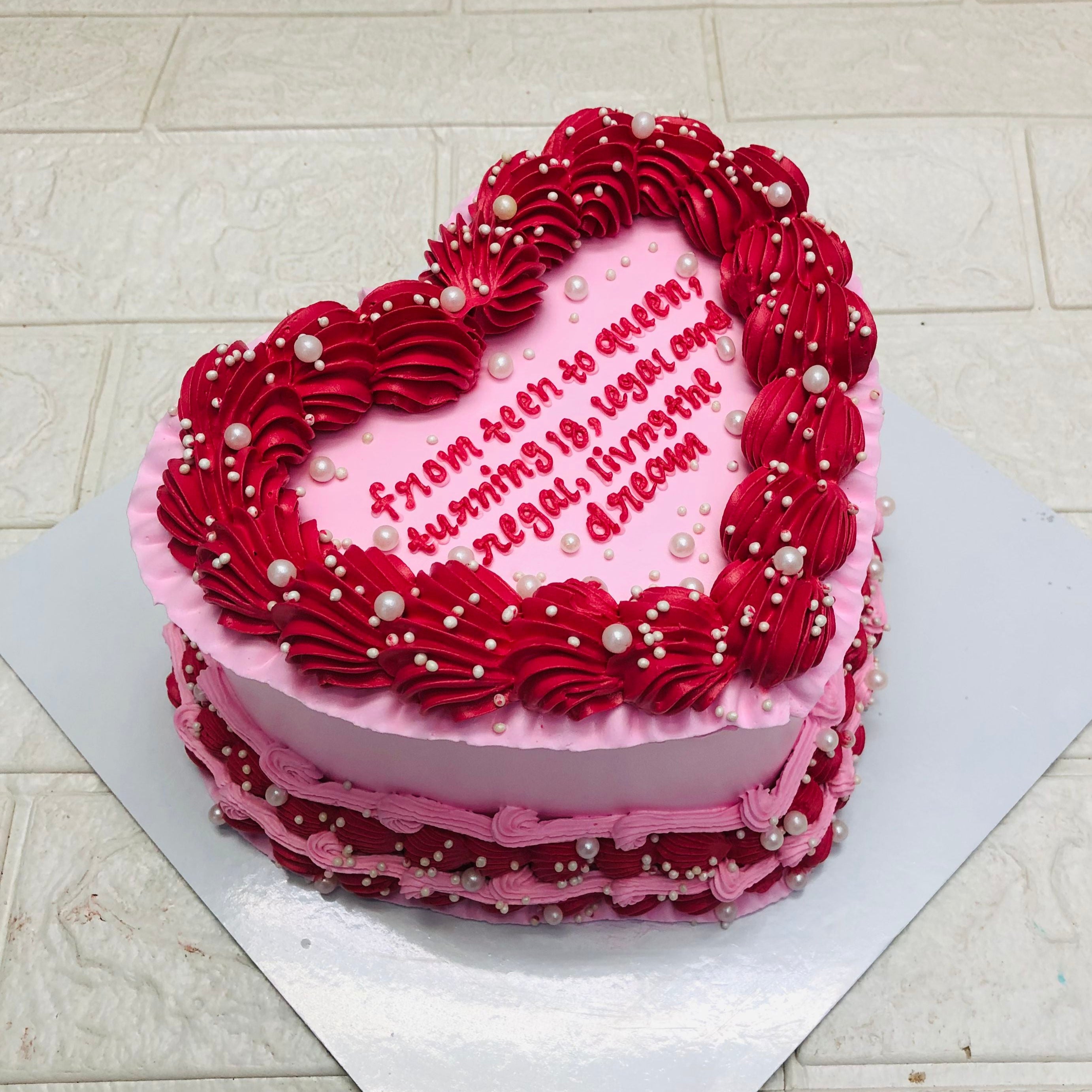A heart-shaped cake adorned with red icing and a heartfelt message, perfect for celebrations of love and affection, image shown from side view.
