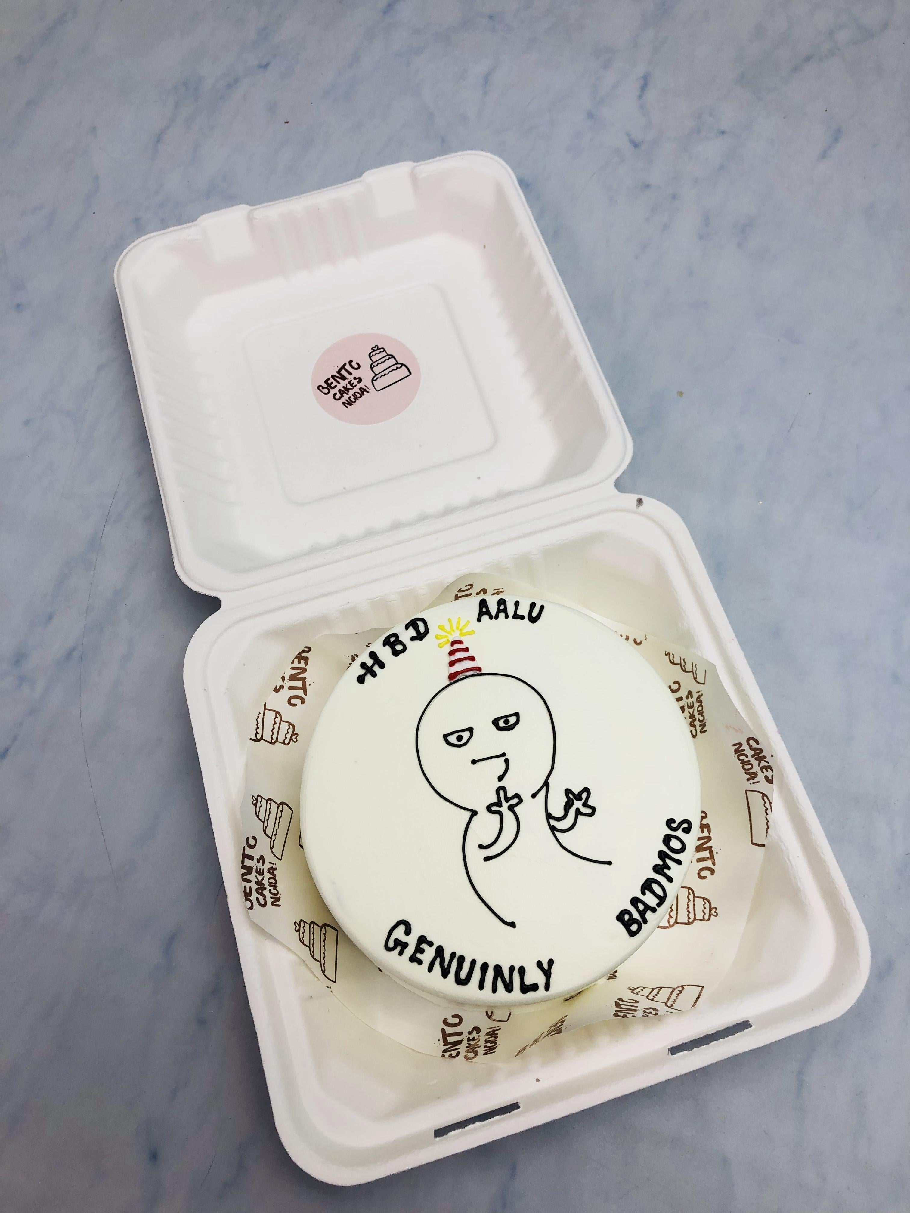 A whitebento cake with a cartoon character sketch and Happy Birthday Text on it.