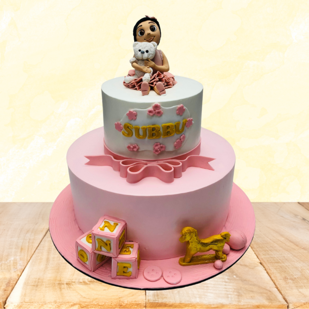 A whimsical cake featuring a baby sitting atop, creating a playful and charming centerpiece for any celebration.