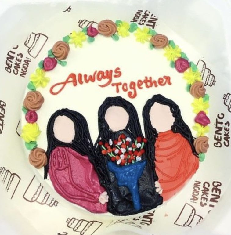 A white bento cake with 3 friends design with colorful florals on it's boundary and they are celebrating their bonding.
