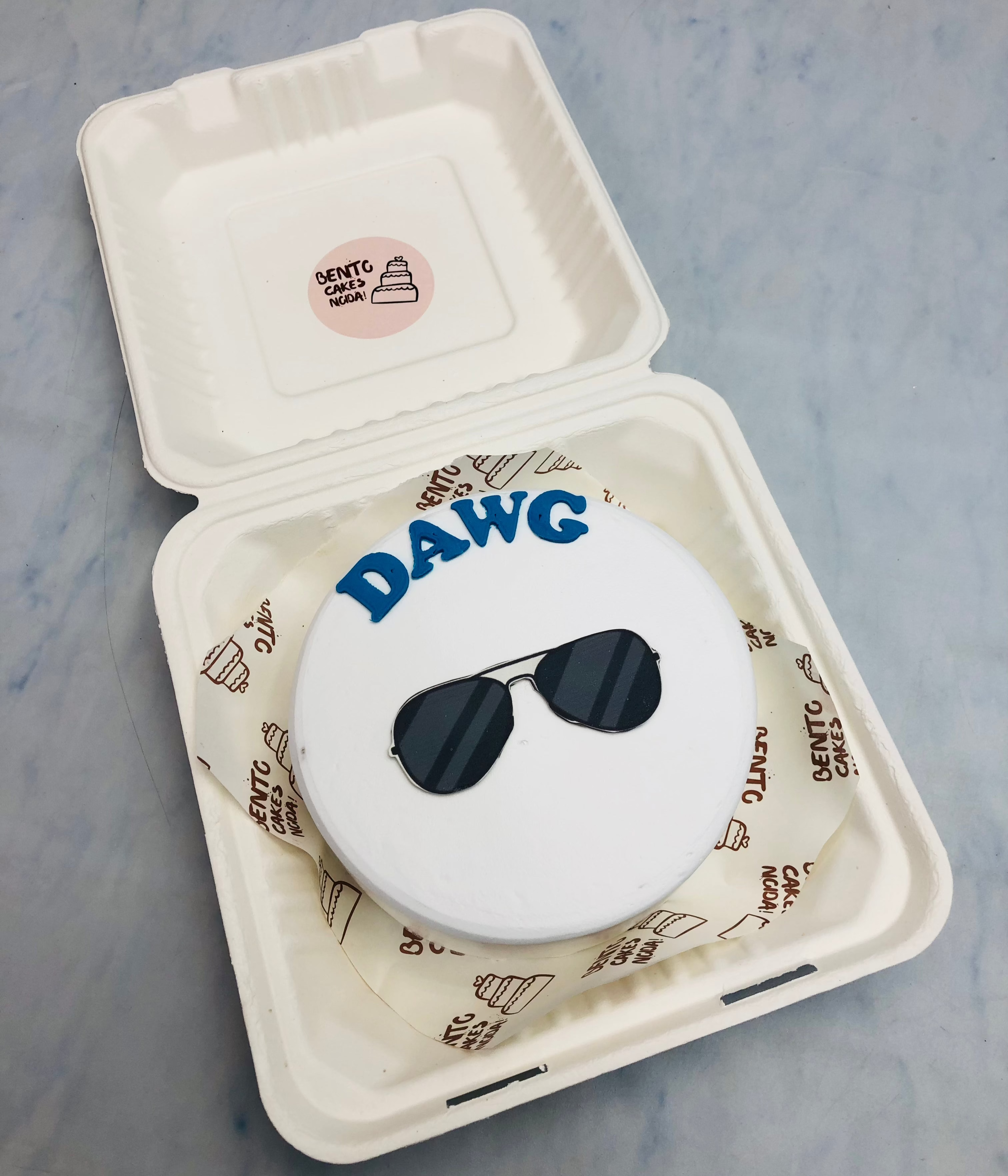 A white bento cake having a goggle print.
