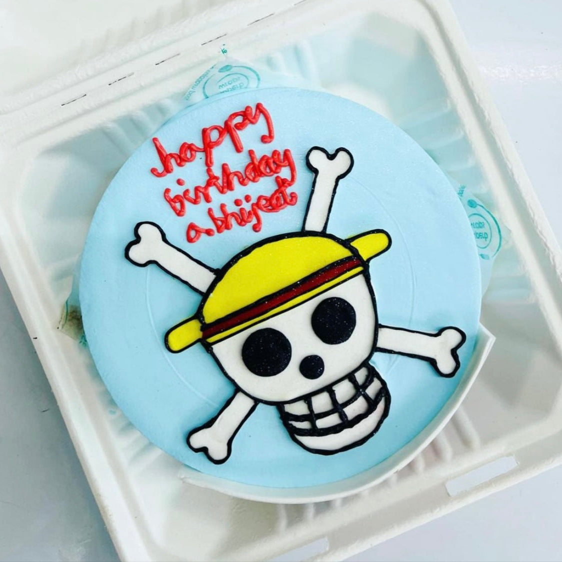 A slice of cake decorated with a skull and crossbones, perfect for a spooky celebration or pirate-themed party.