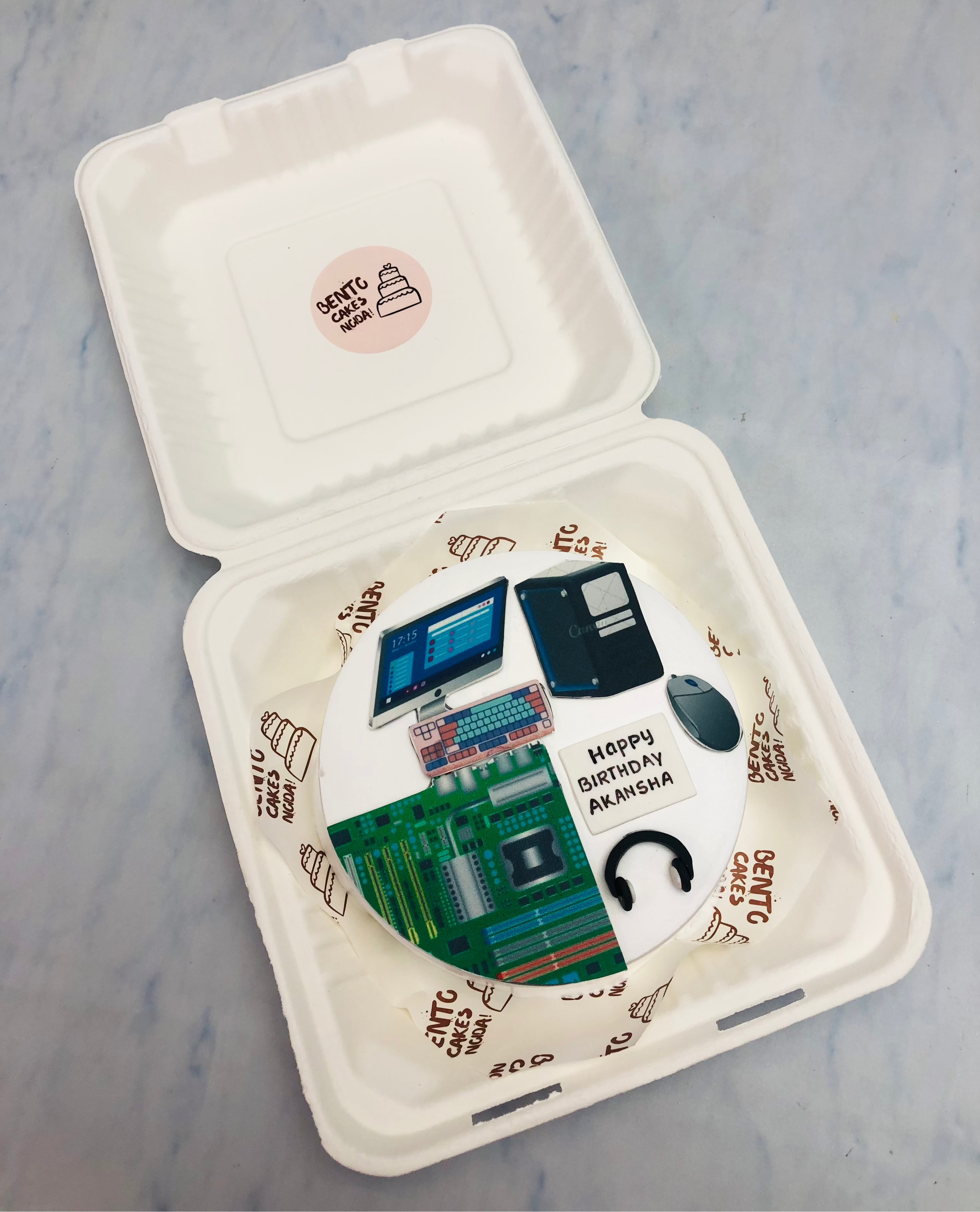 A white bento cake is designed for hadware engineers birthday with her computer components print.