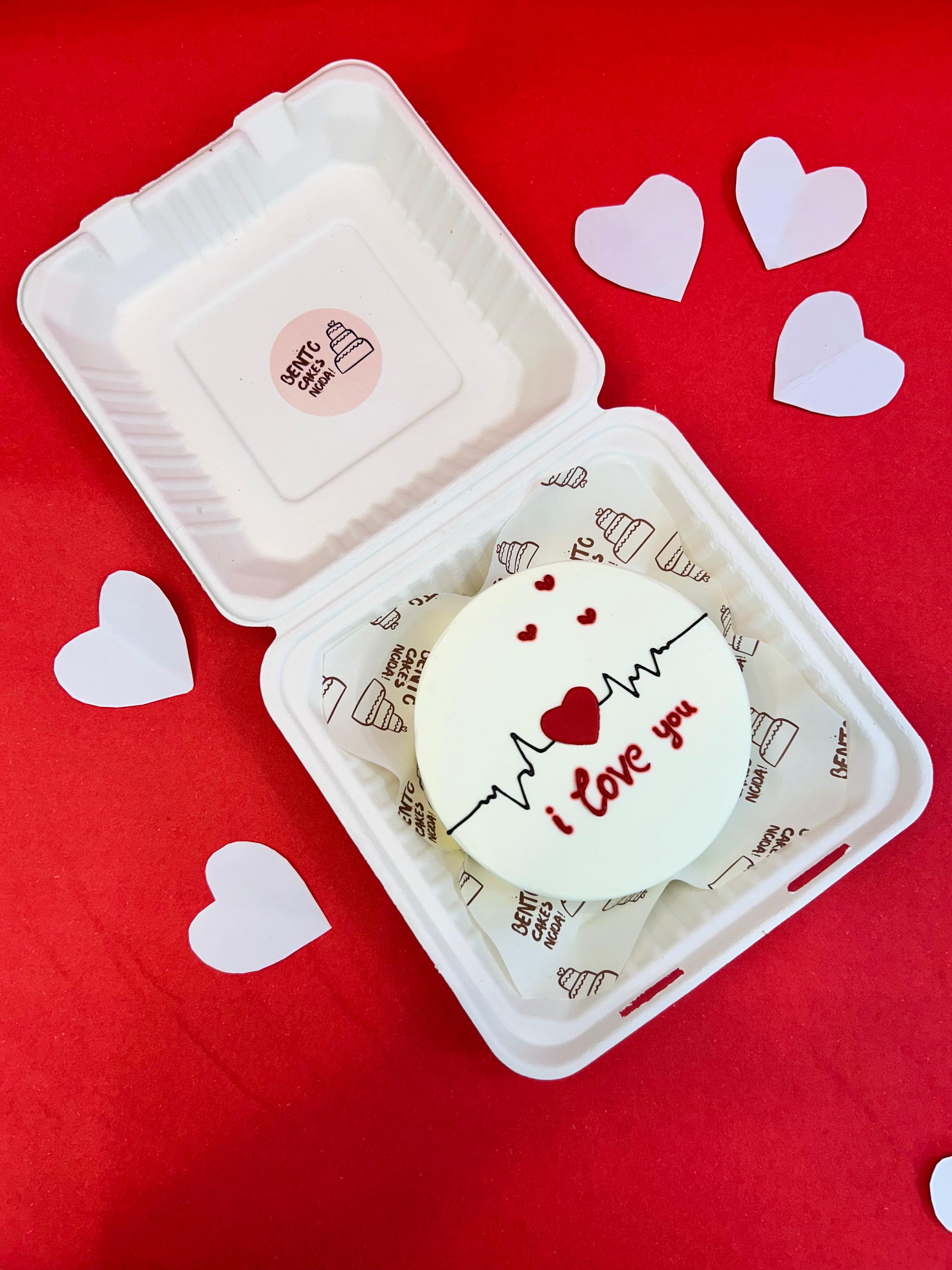 A white box featuring a heart-shaped design on top, adorned with the text "I love you."