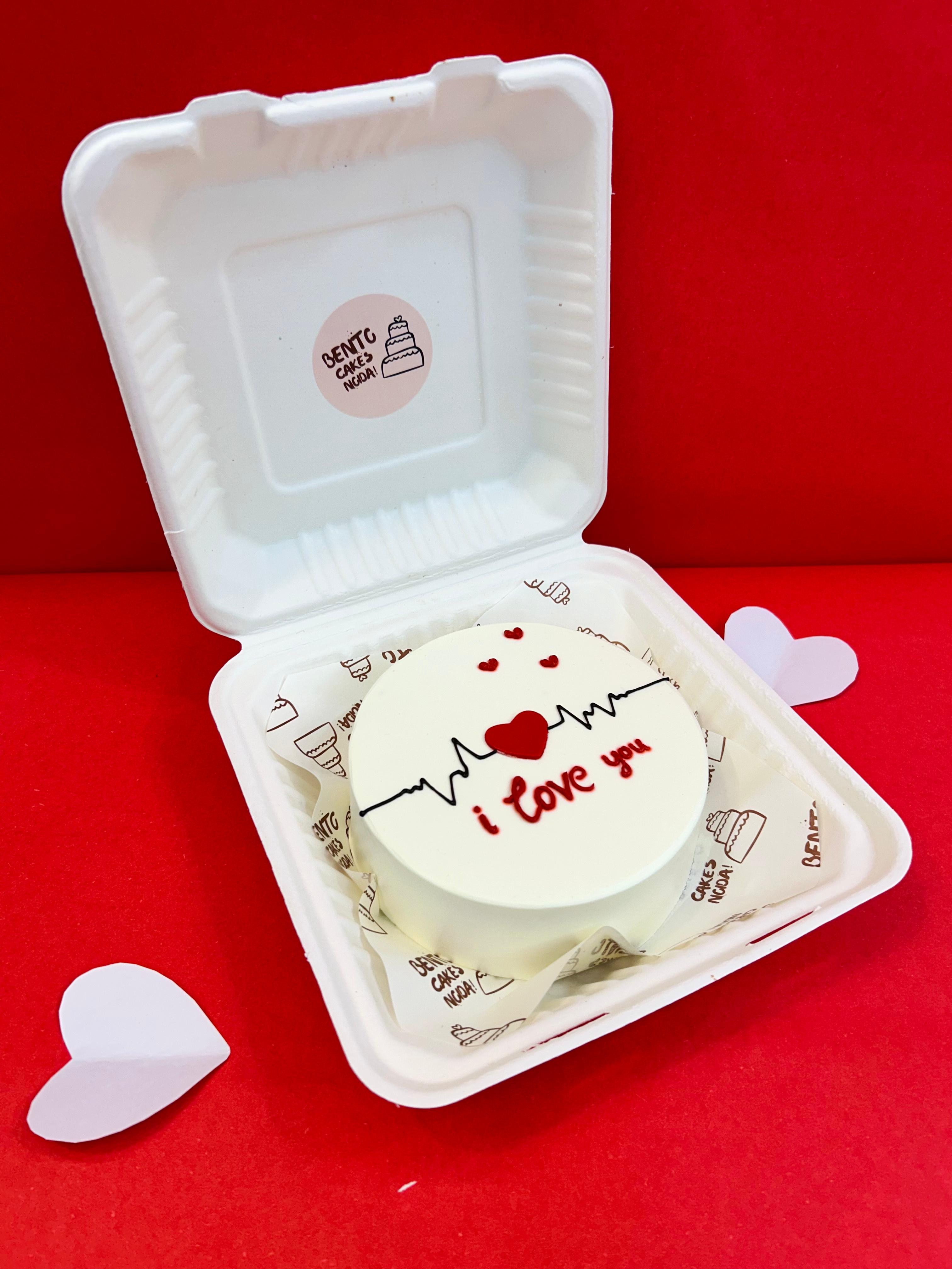 A white box featuring a heart-shaped cookie on top, adorned with the text "I love you" with side view.