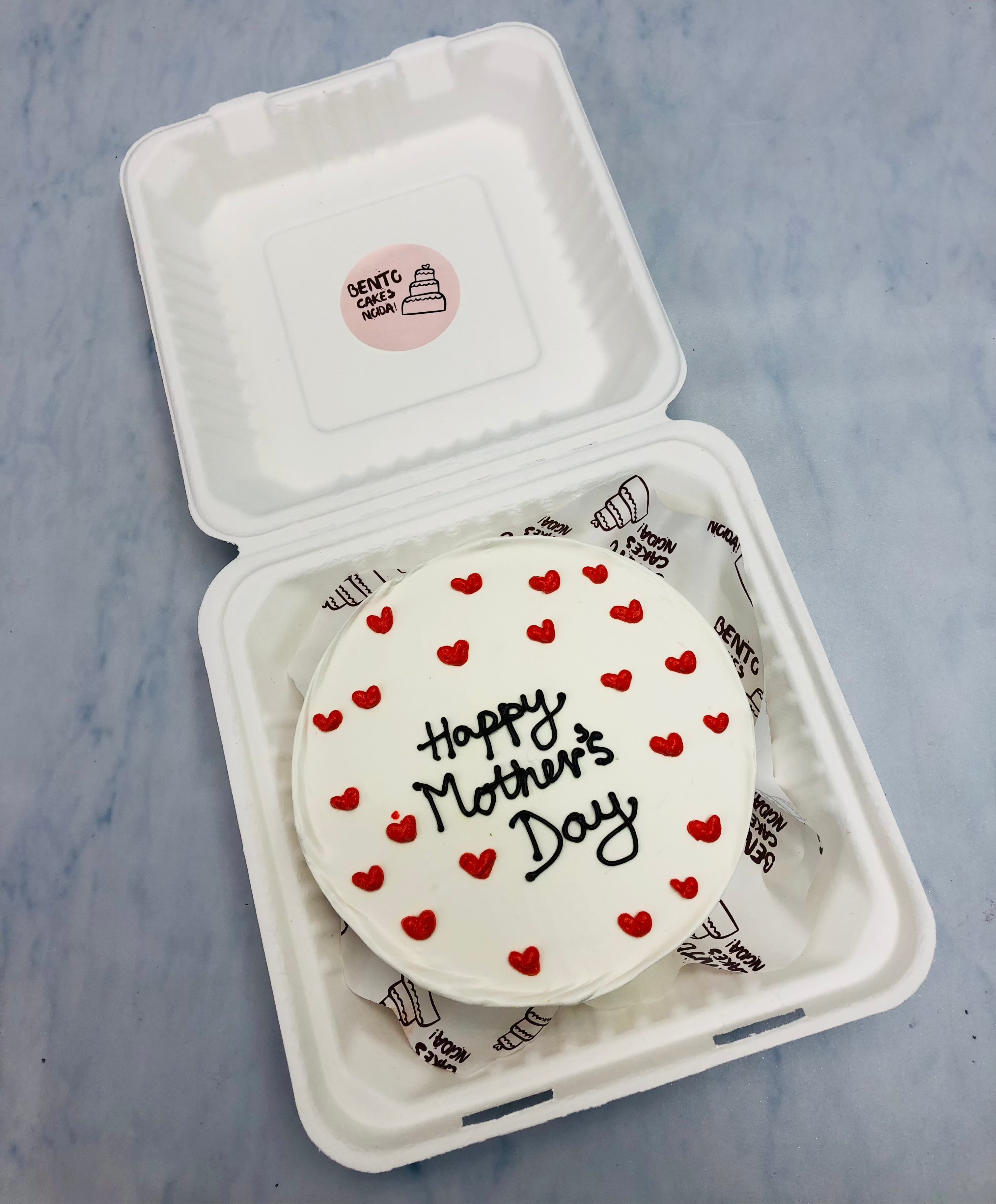 A white bento cake is filled with red hearts design for Mother's Day.