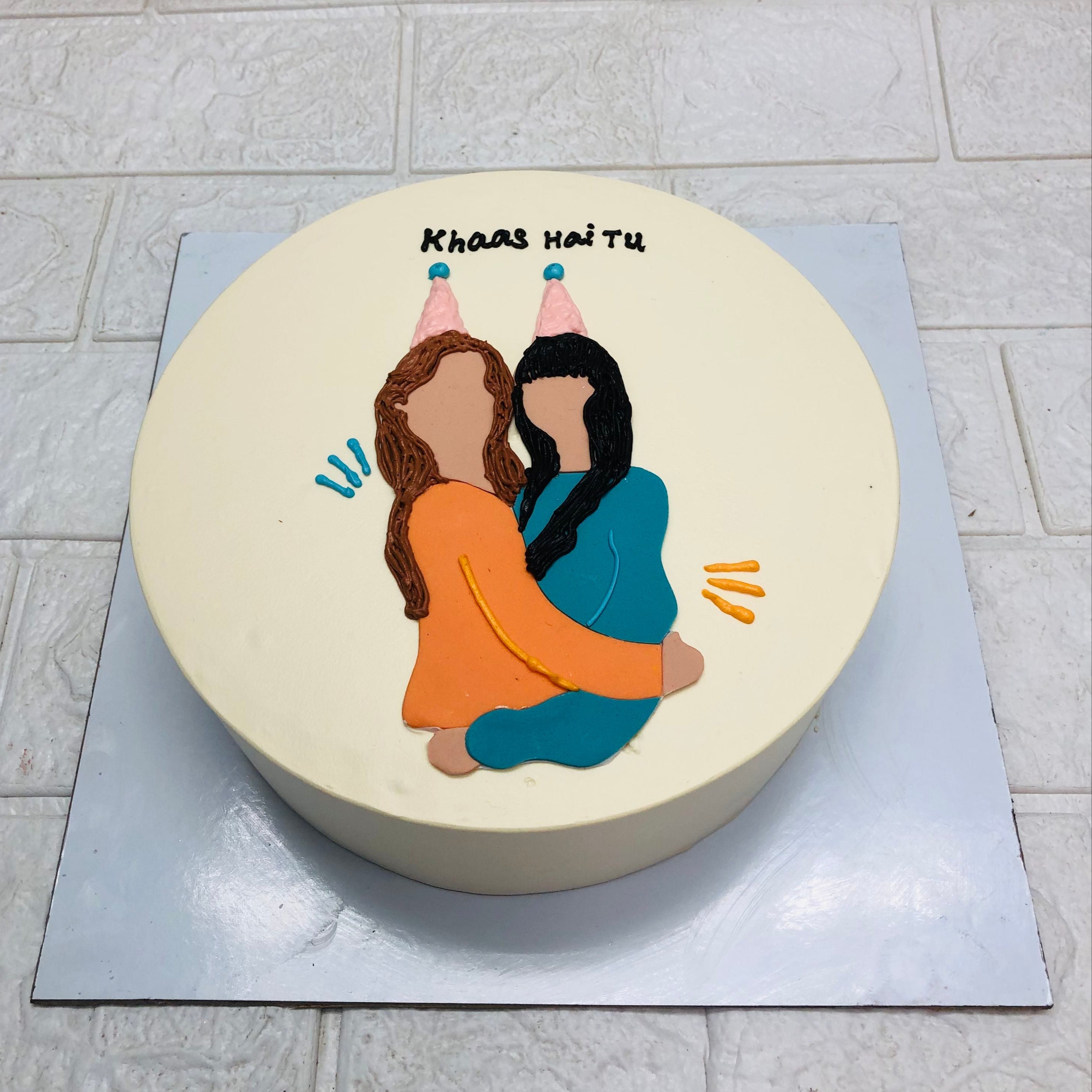 A beautifully decorated cake showcasing two women hugging, representing love and joy in a festive setting.