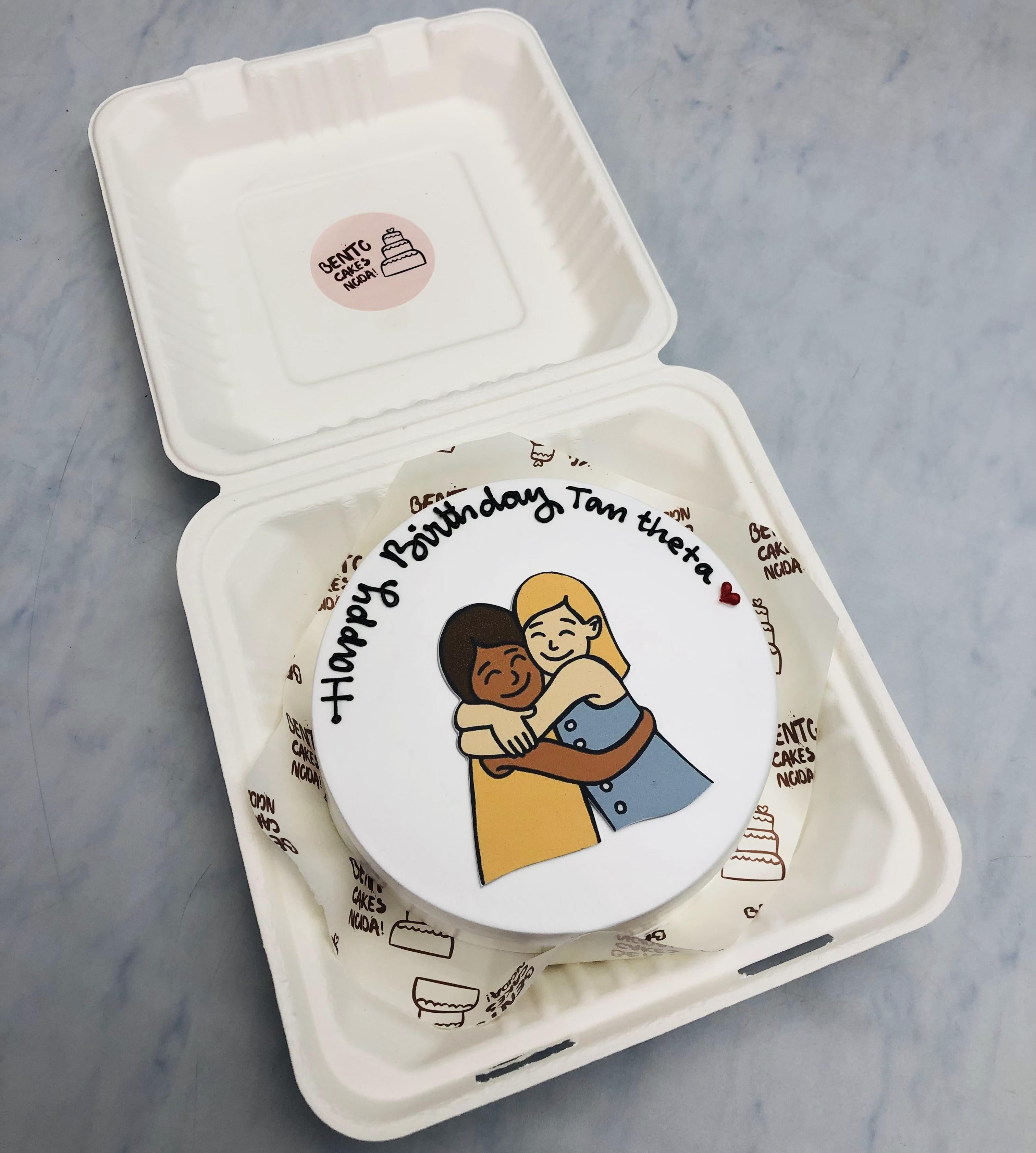 Two friends hugging picture on a white bento cake.