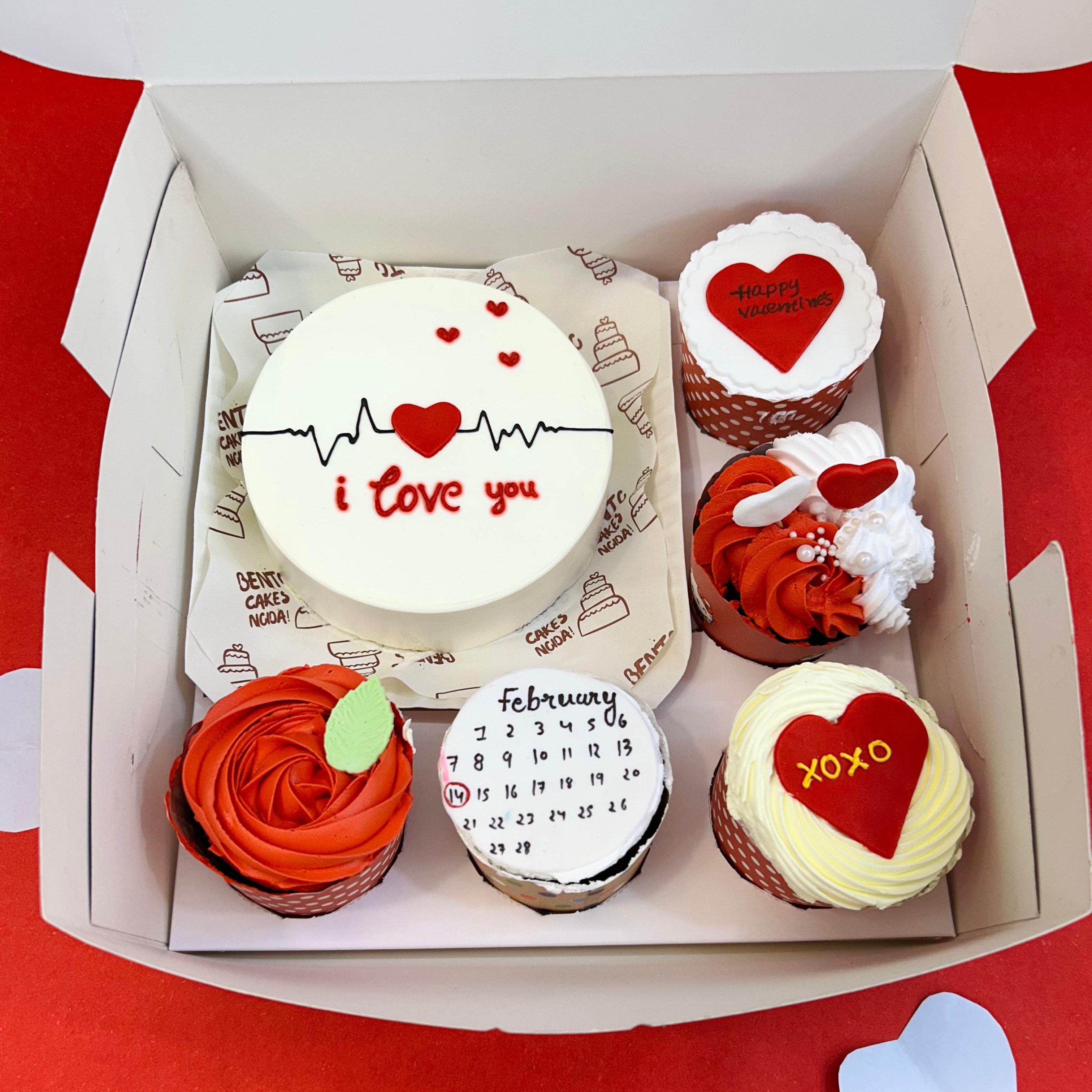 A box of heart-shaped 5 cupcakes set alongside a bento cake, beautifully arranged for a delightful presentation.