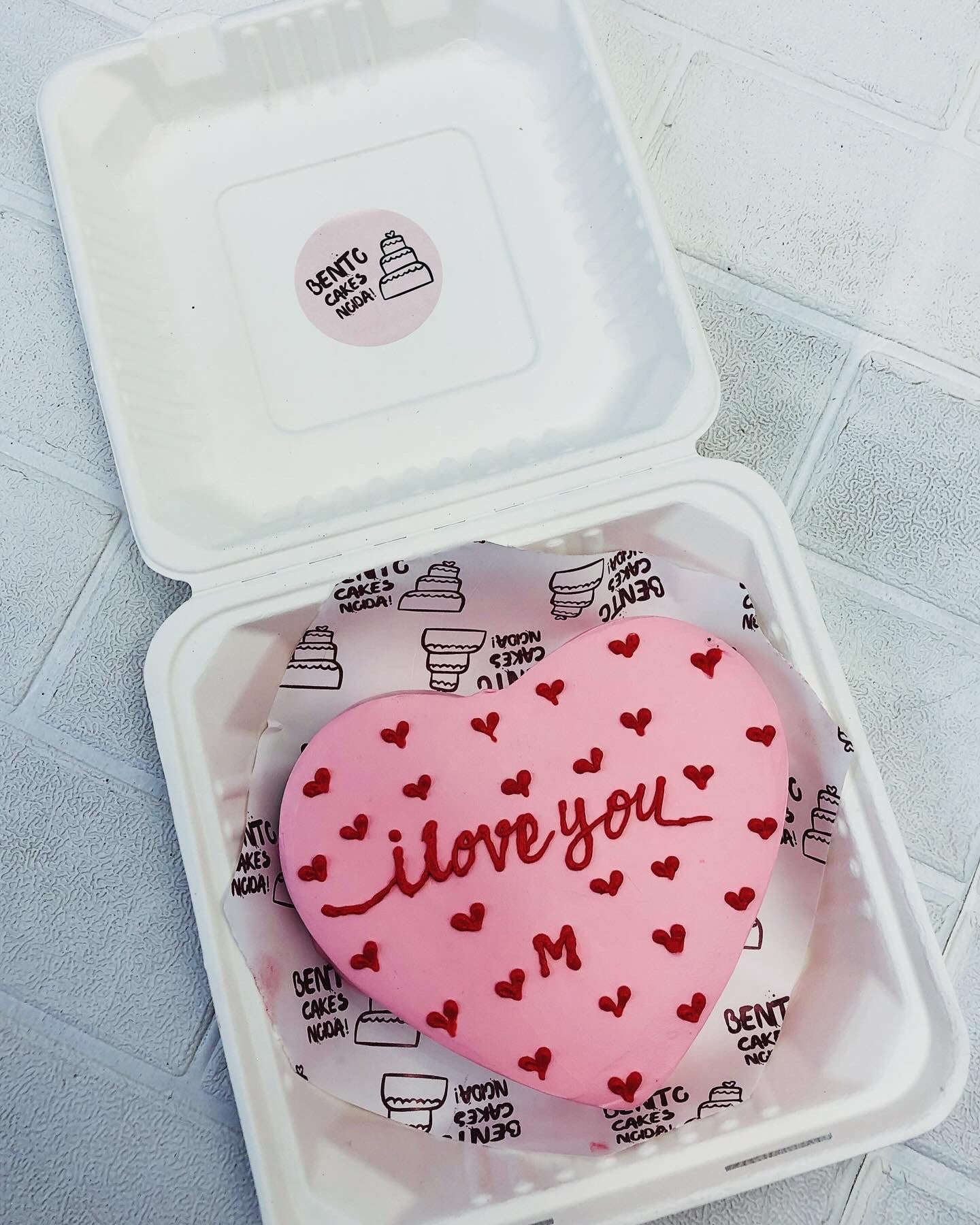 An I Love You Pink Heart cake in a bento box with little red hearts on it with a loving text.