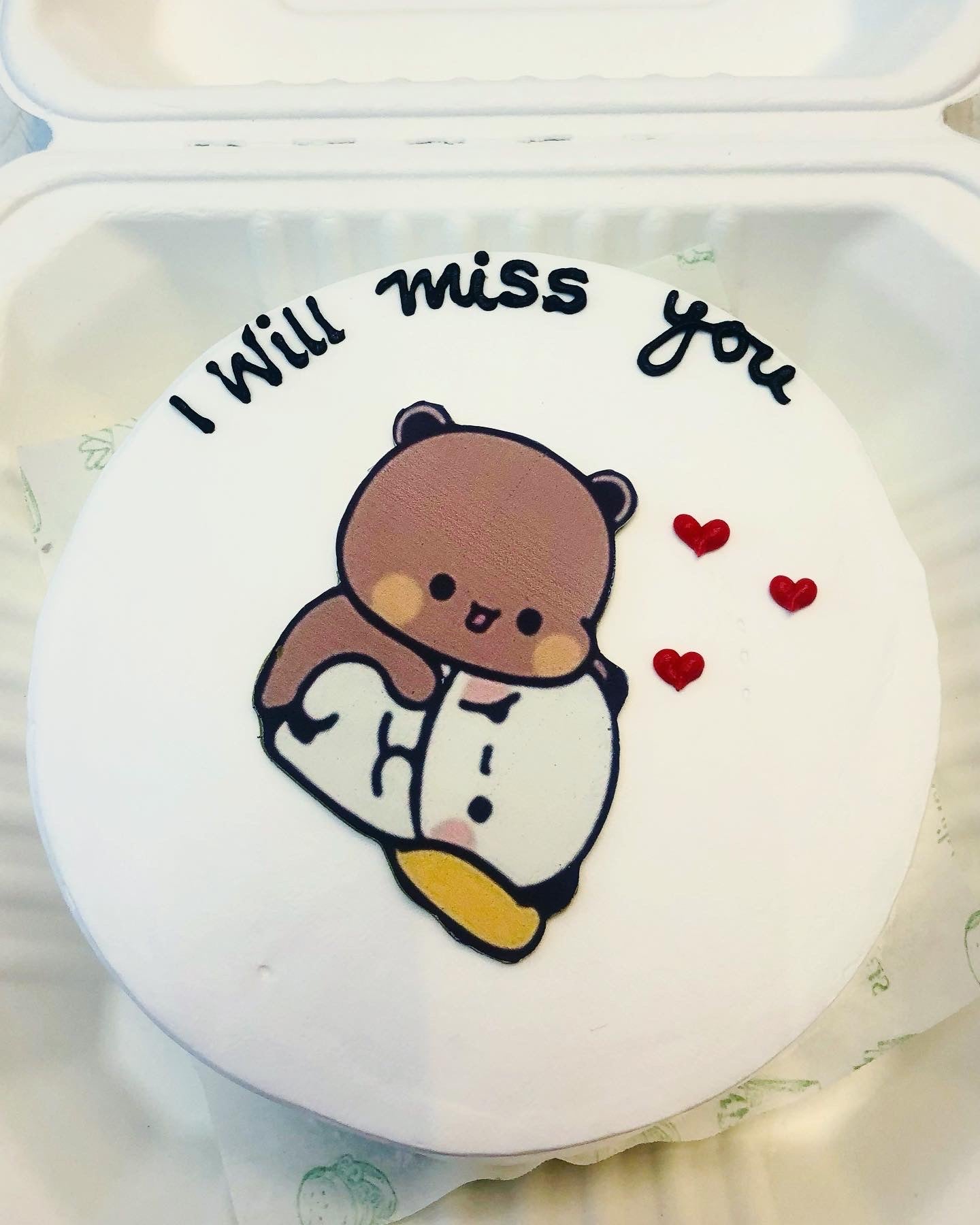 A beautifully decorated cake with the words "I Will Miss You" written on top, surrounded by red Hearts design.