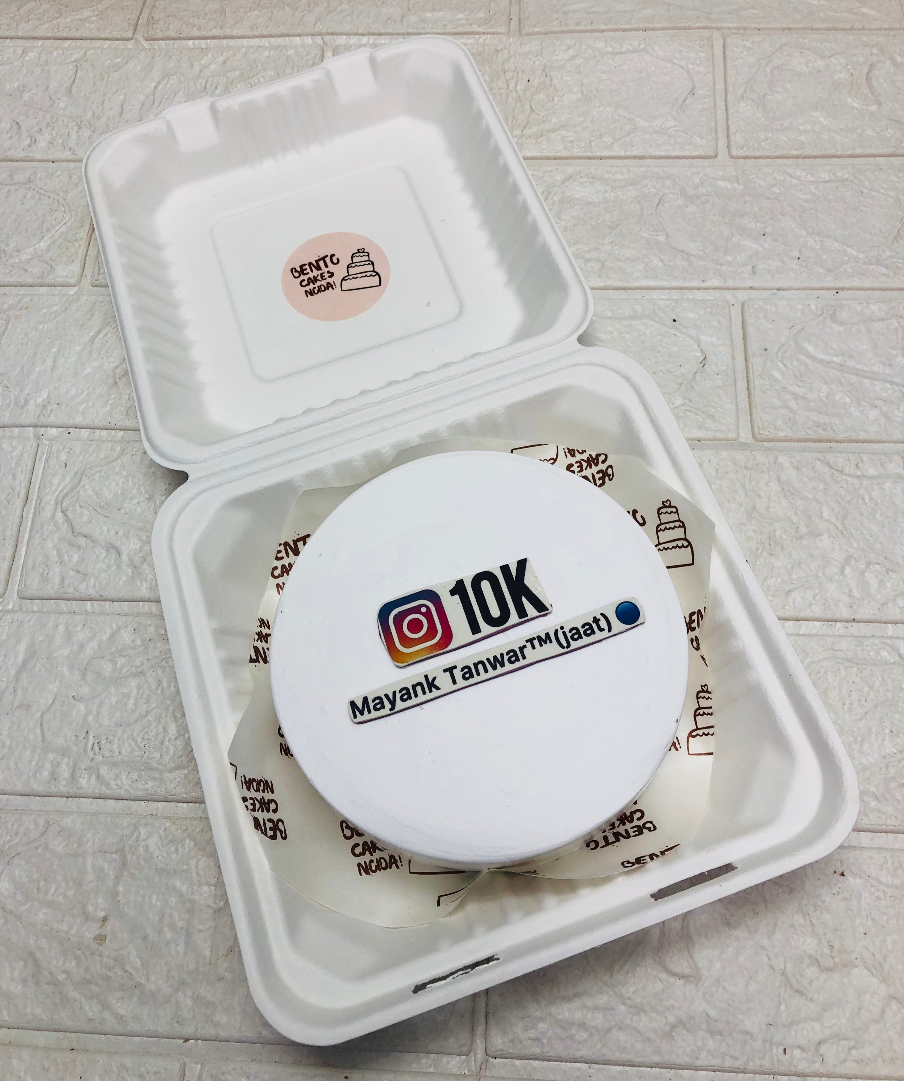 A white bento cake designed for Instagram 10K followers theme.