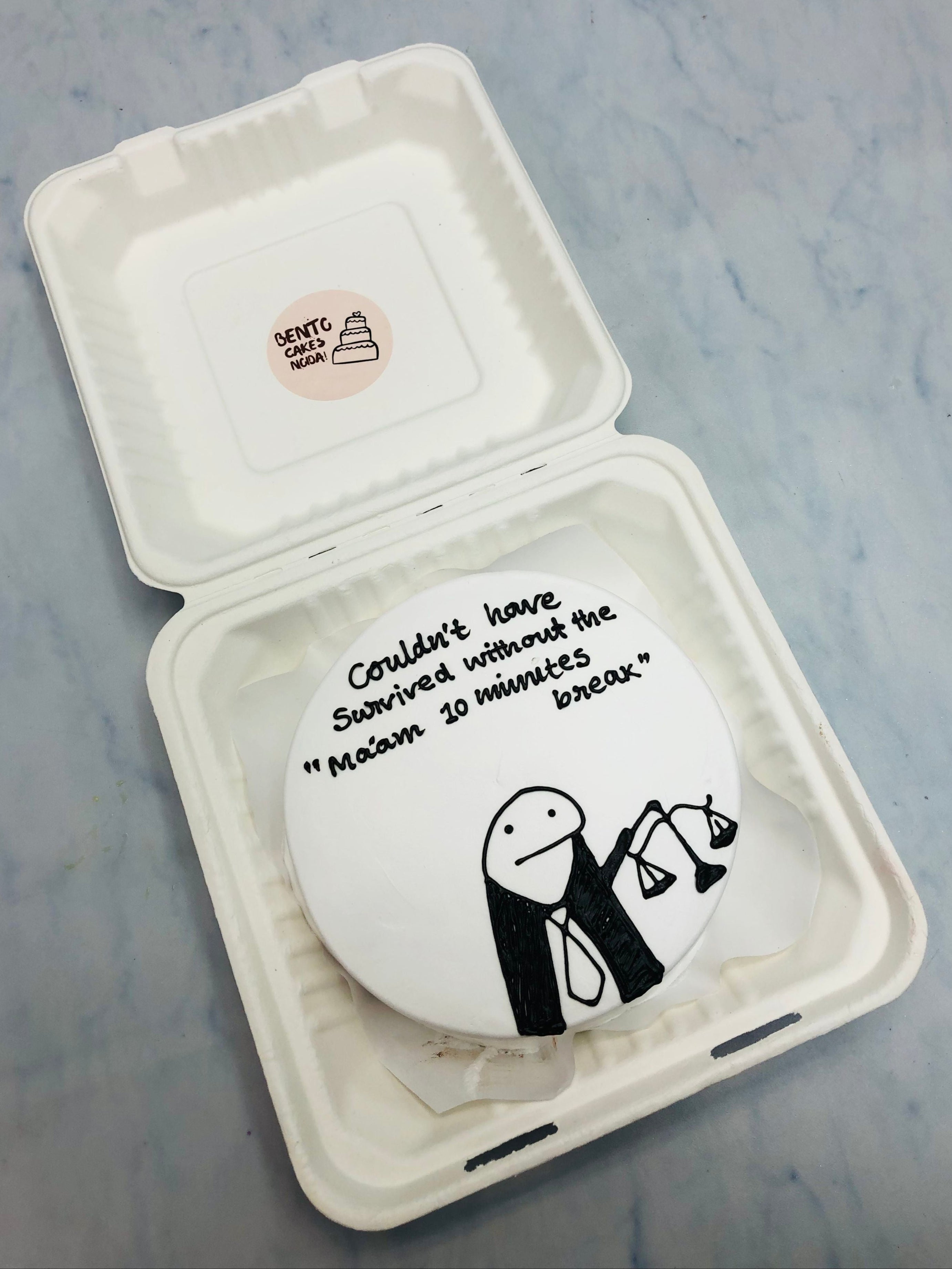 A white bento cake is designed with a mimi cartoon character in Judge profession