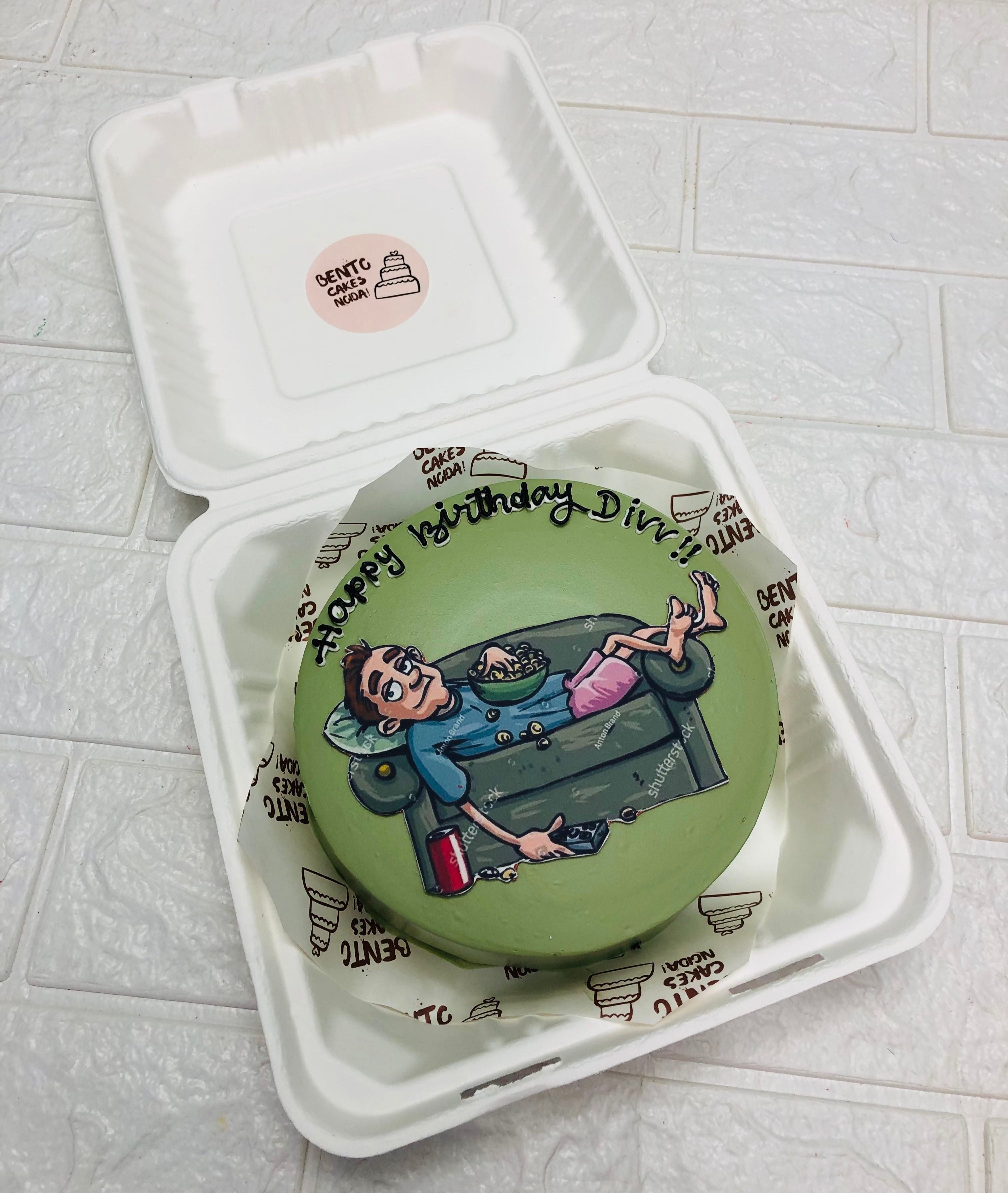 A green bento cake is designed for a lazy and foody mens birthday.