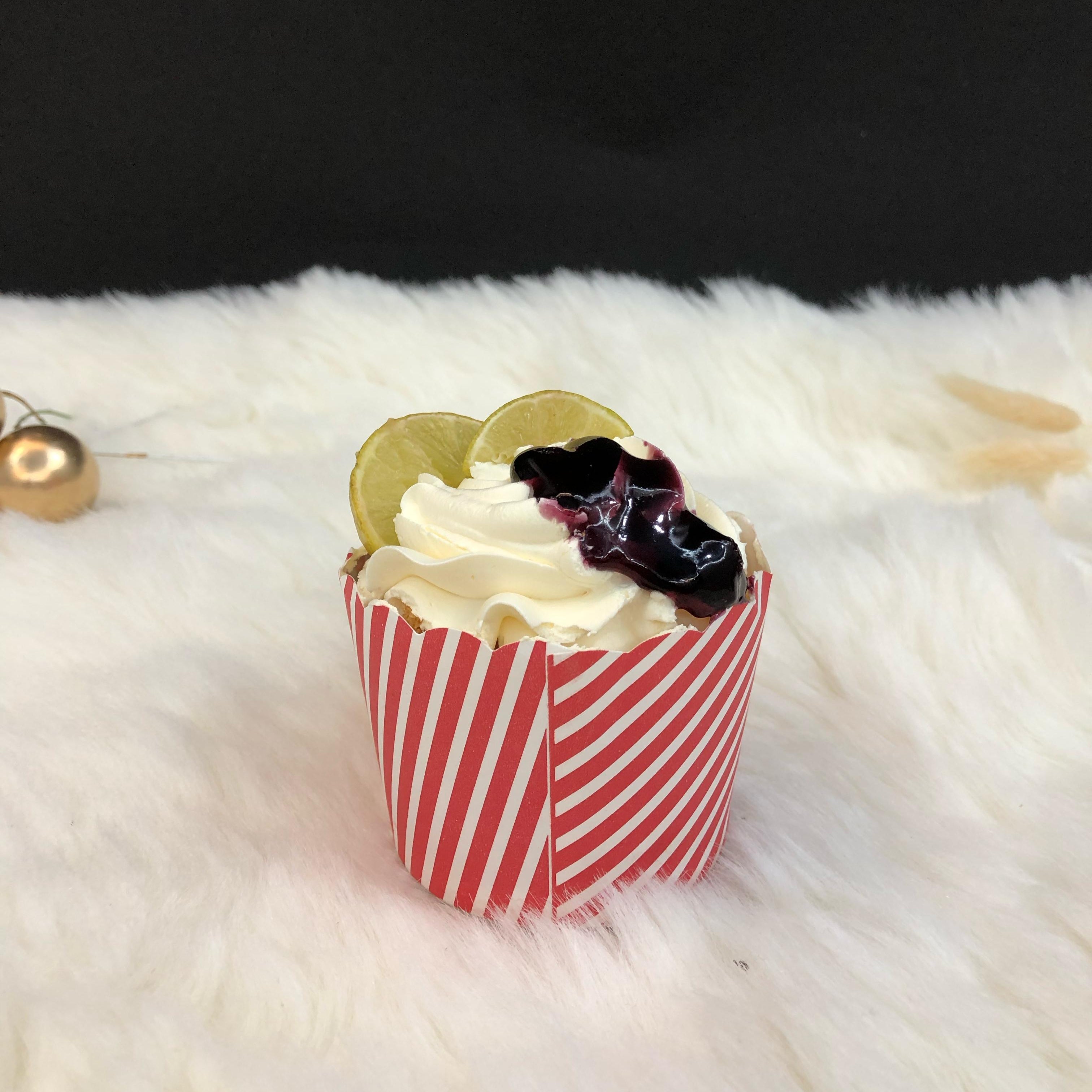 A cupcake filled with lemon and blueberry flavour.