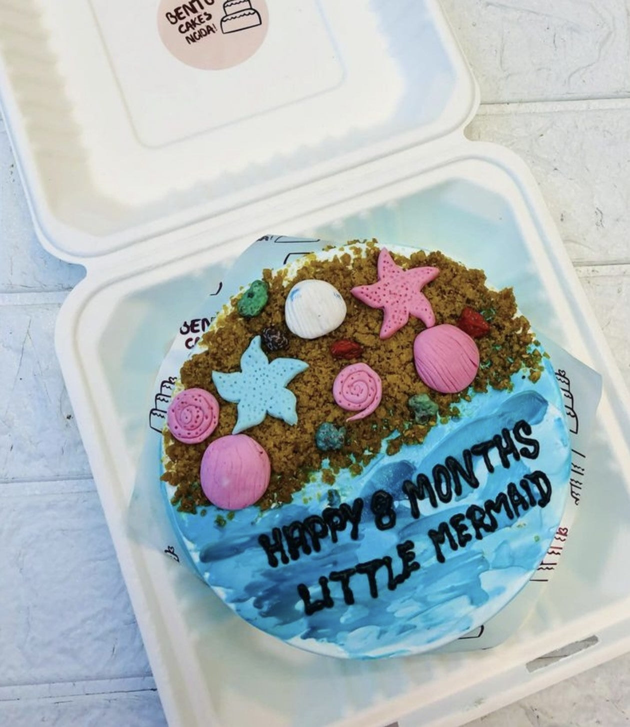 A light blue bento cake based on little mermaid theme for a baby girl.