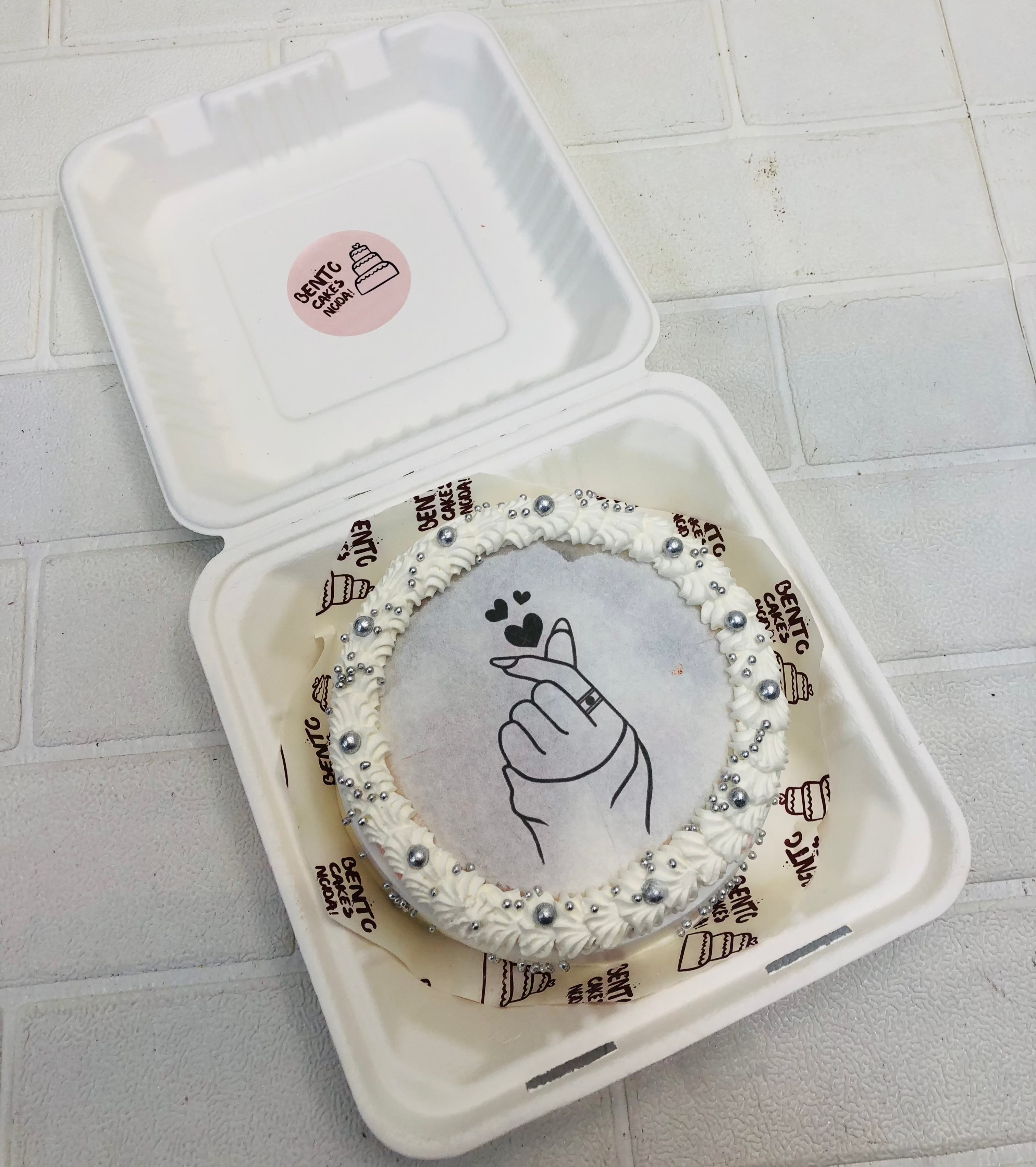 A pearl white fire bento cake withn love theme on fire paper.