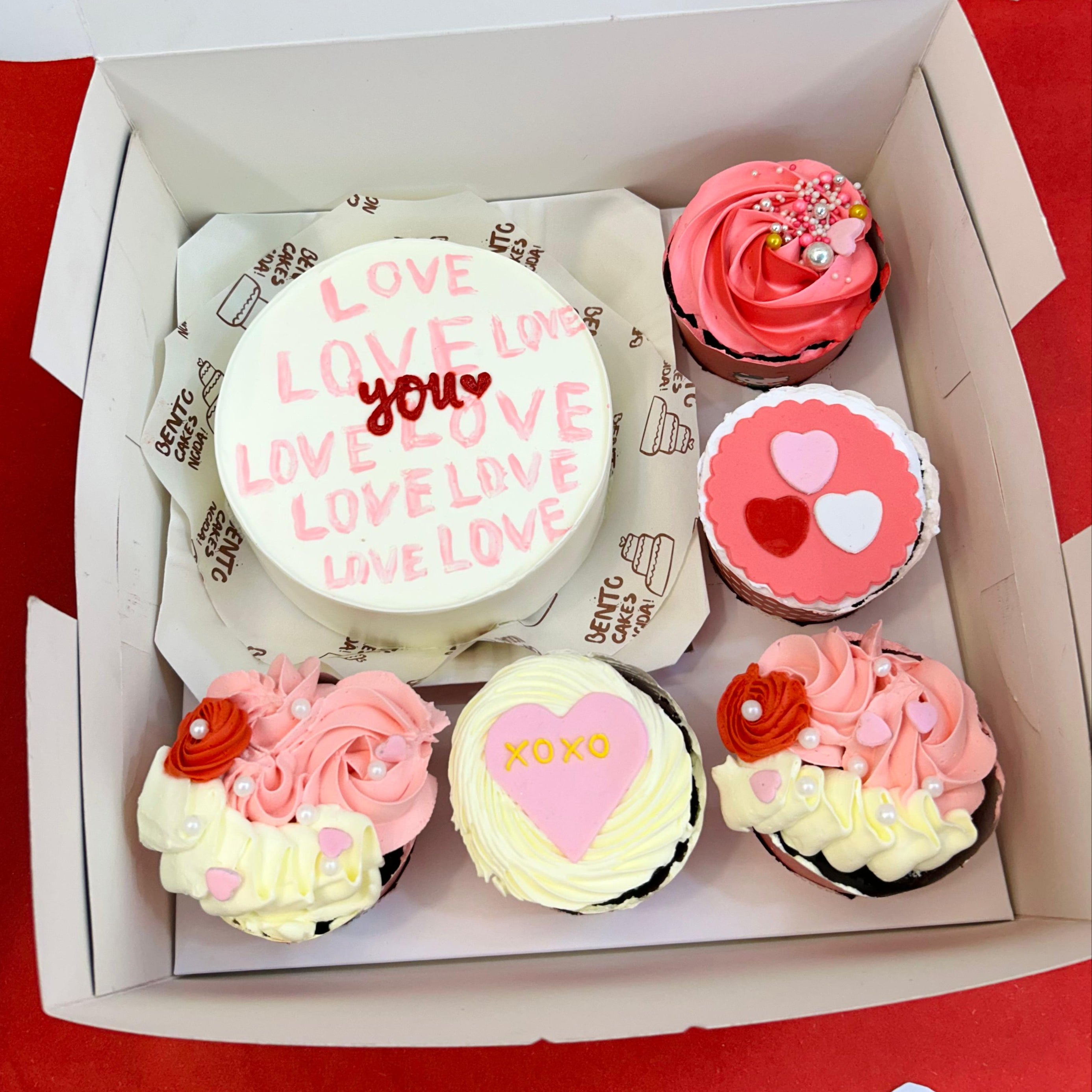 Valentine's Day cupcakes in a decorative box, showcasing a "Love You" theme alongside a delightful bento combo cake.