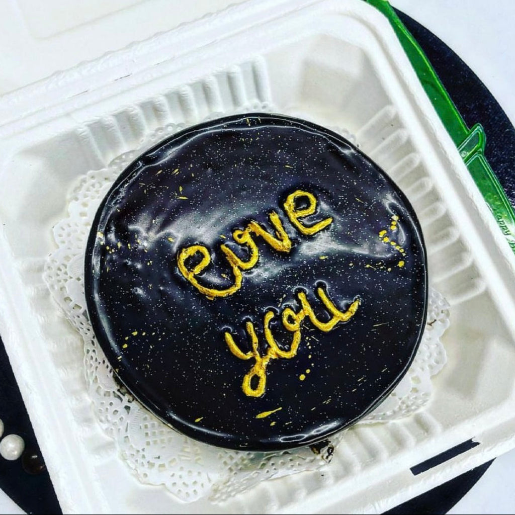 A beautifully decorated cake featuring the words "Love You" elegantly written on top.