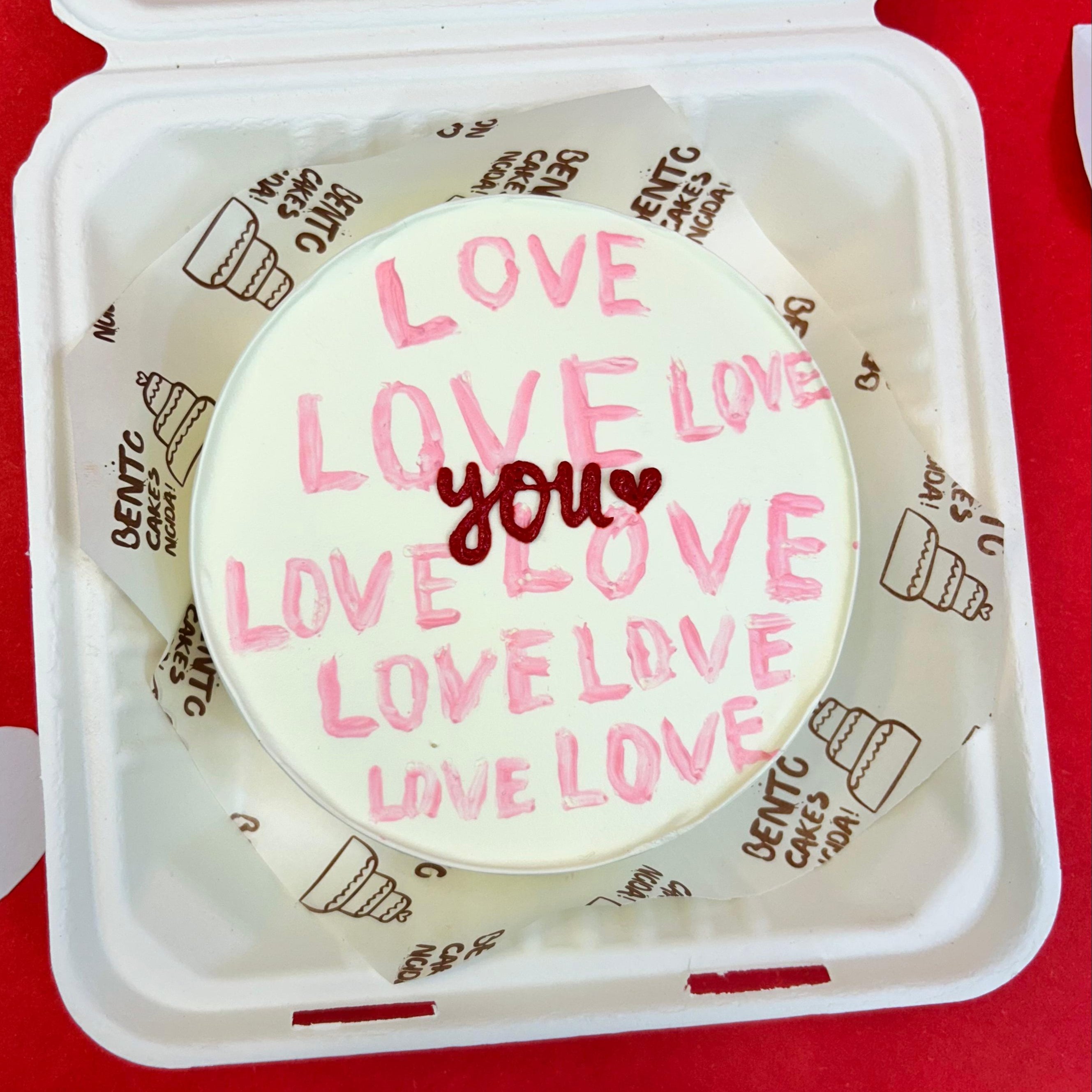 A white box featuring a cake that displays the words "Love You" in a charming design with front view.